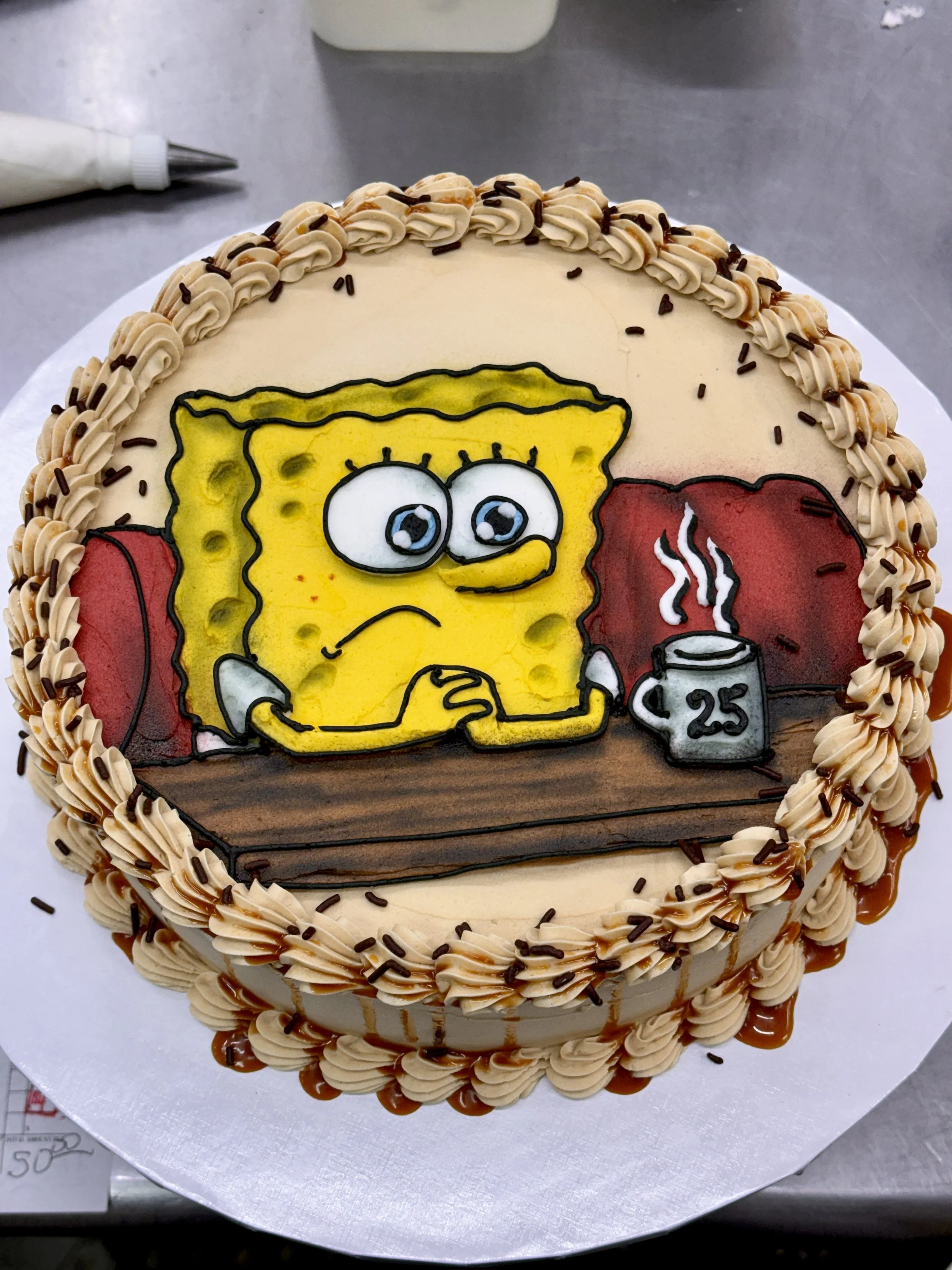 A cake decorated with an Edible image of SpongeBob SquarePants watching TV with a can of beer and a beer mug marked with '25' on the side. The cake has a border of beige frosting with chocolate sprinkles.