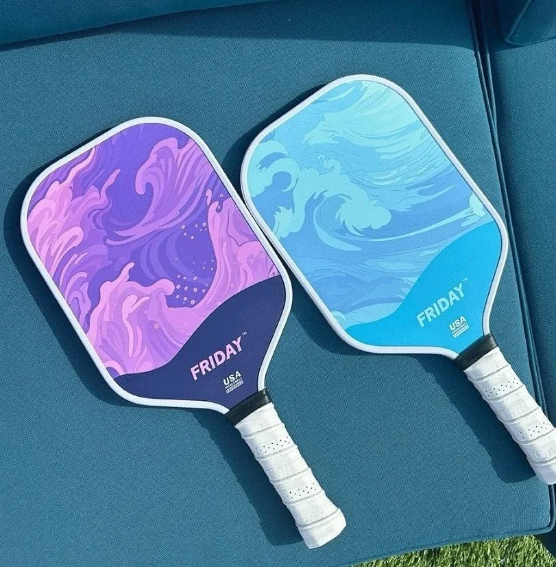 A black pickleball paddle with a colorful digital design on its face, featuring the brand name JOOLA and the word STRATOS.