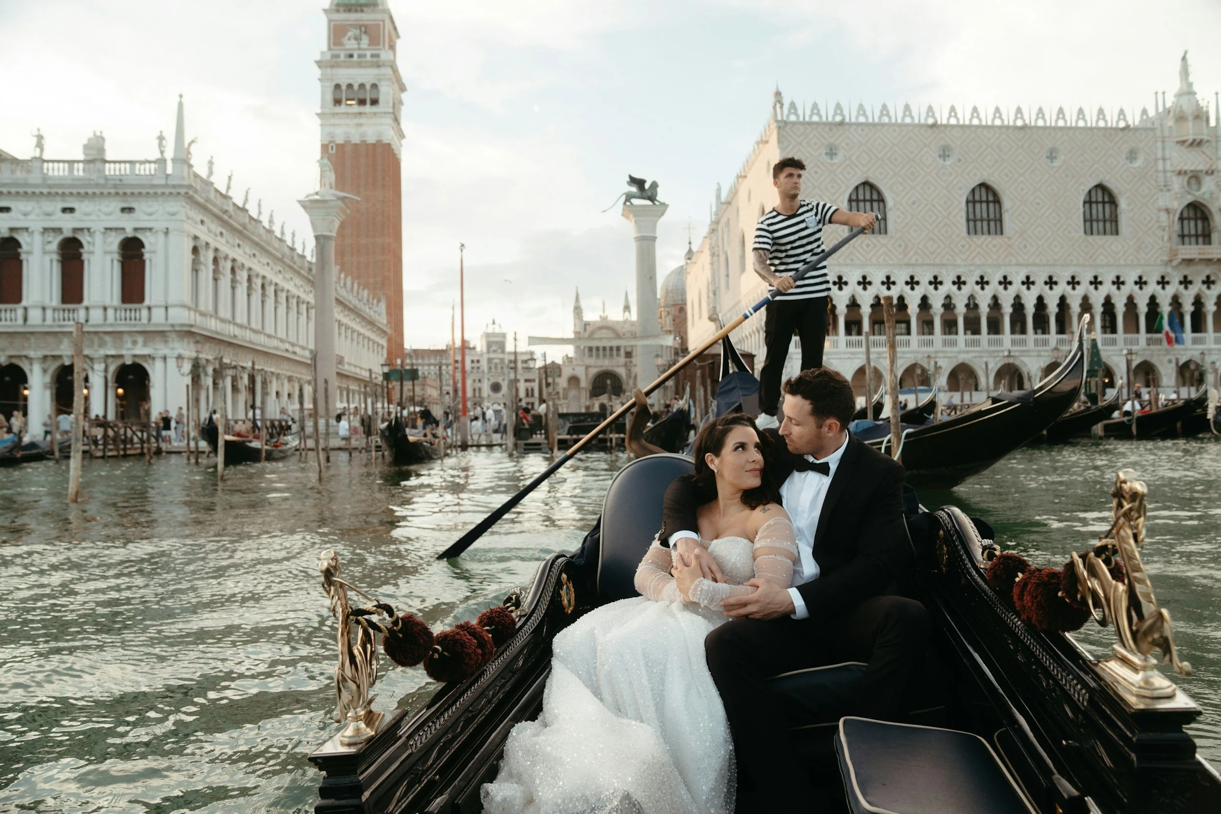 Italian bride and groom riding in a gondola in Venice