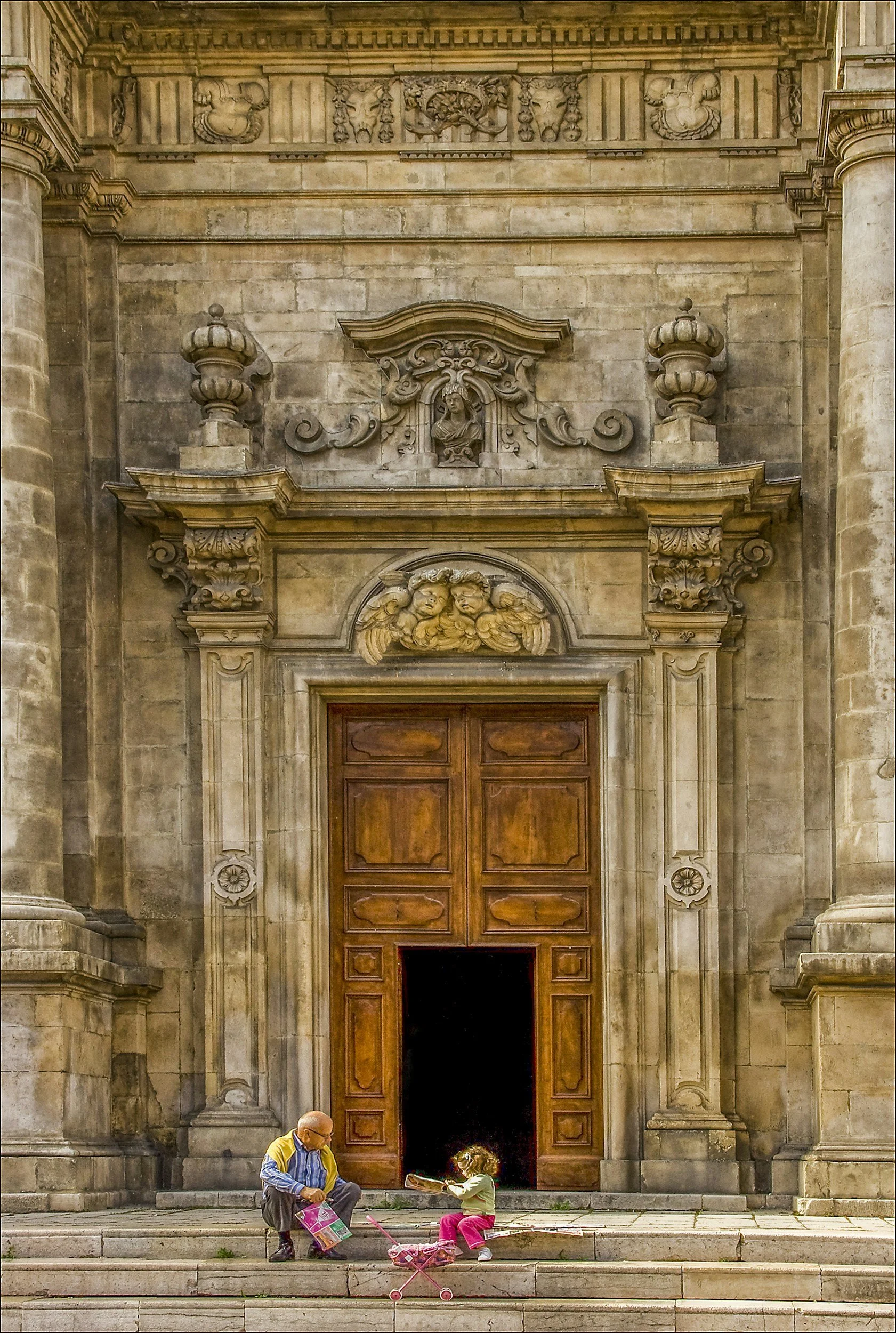 Little girl sitting on the steps of a historic church in Italy