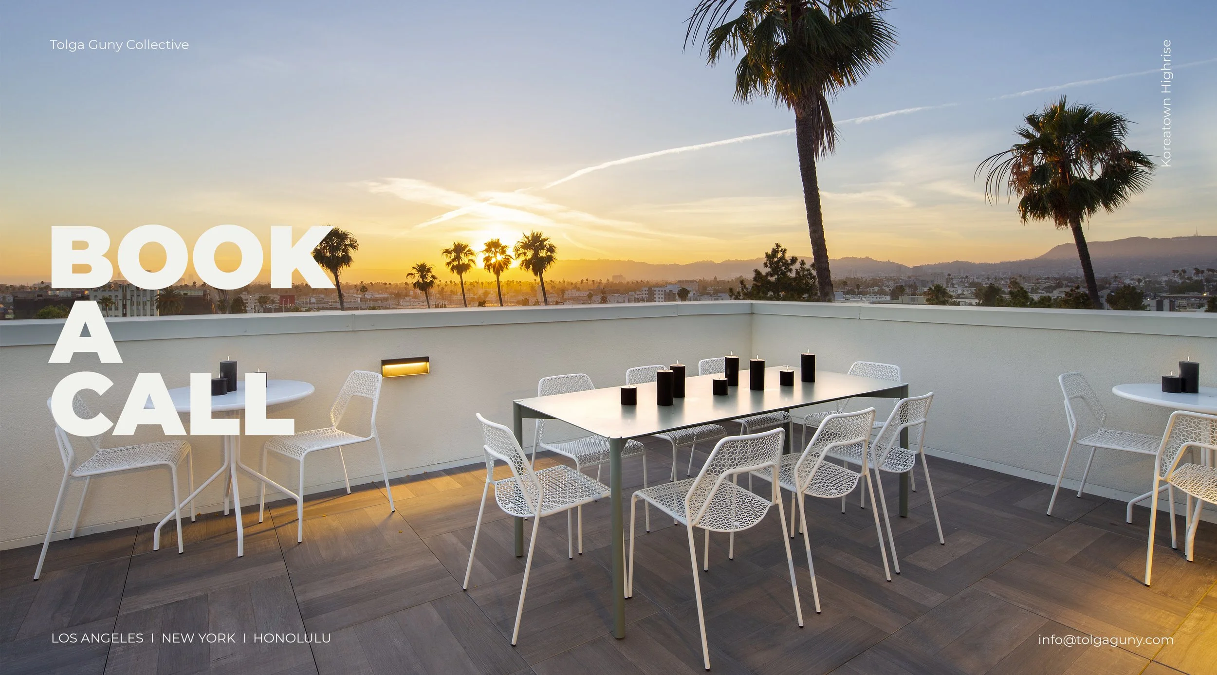 Rooftop terrace with a sunset view over Los Angeles, featuring white chairs and tables, palm trees, and a cityscape in the distance.