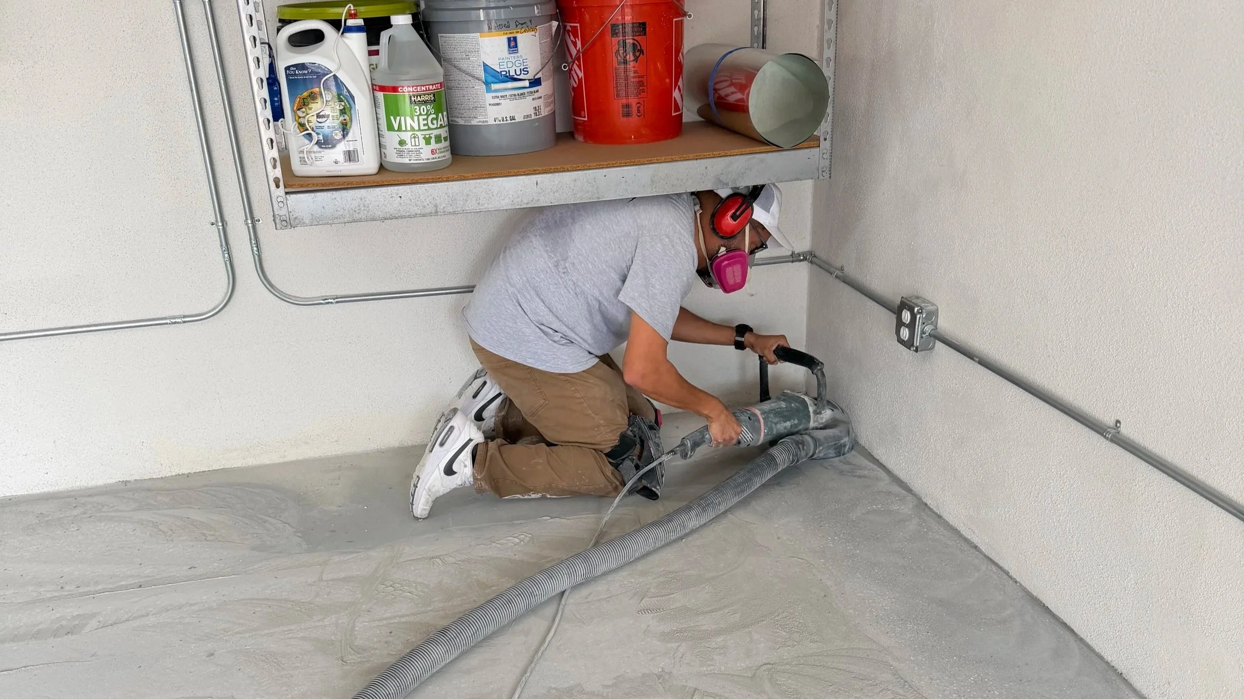 Contractor Grinding Garage Floor Before Epoxy And Polyaspartic Coating