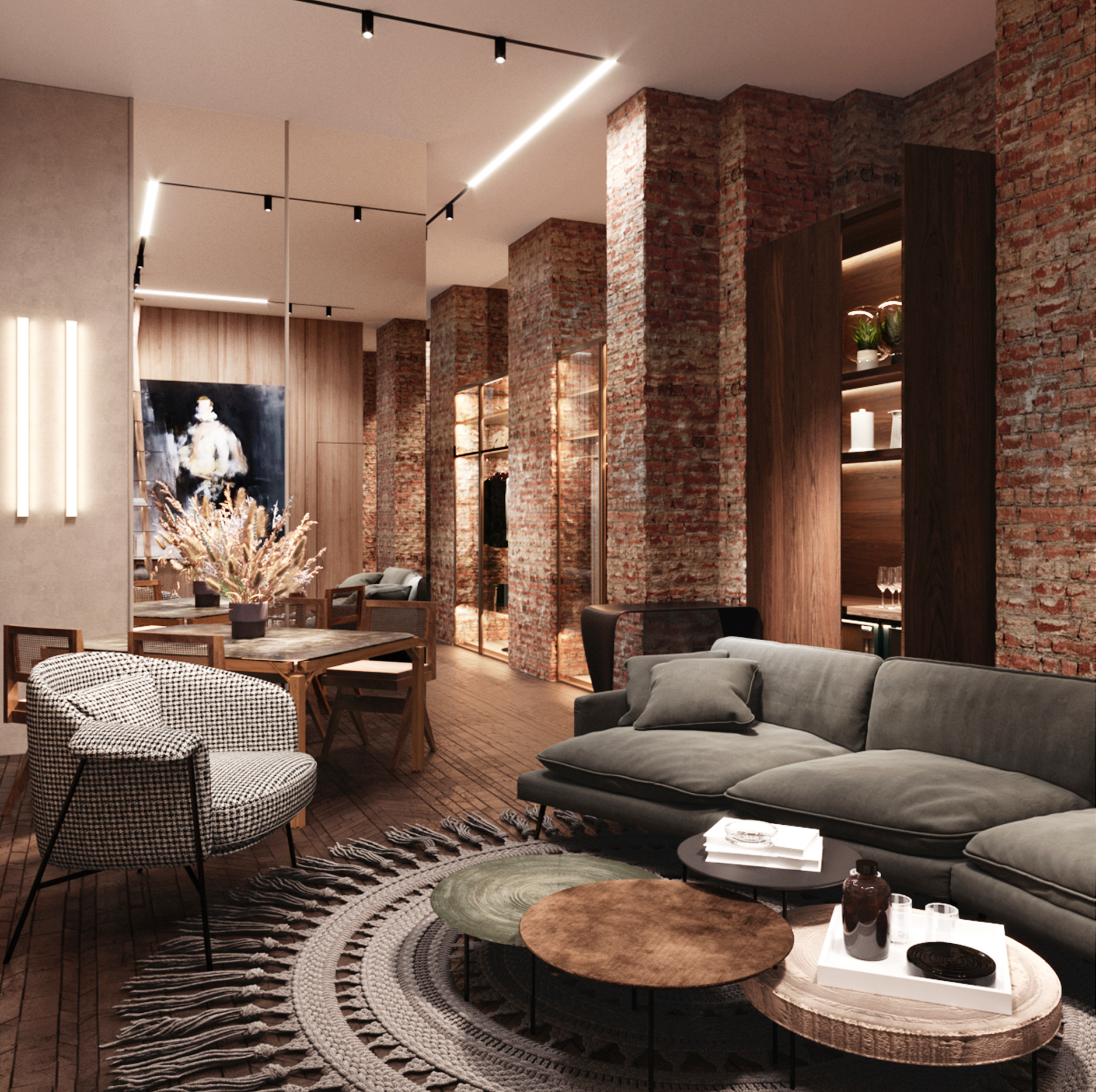 Modern living room with exposed brick walls, track lighting, a gray sectional sofa, round coffee tables, patterned chairs, and decorative plants.