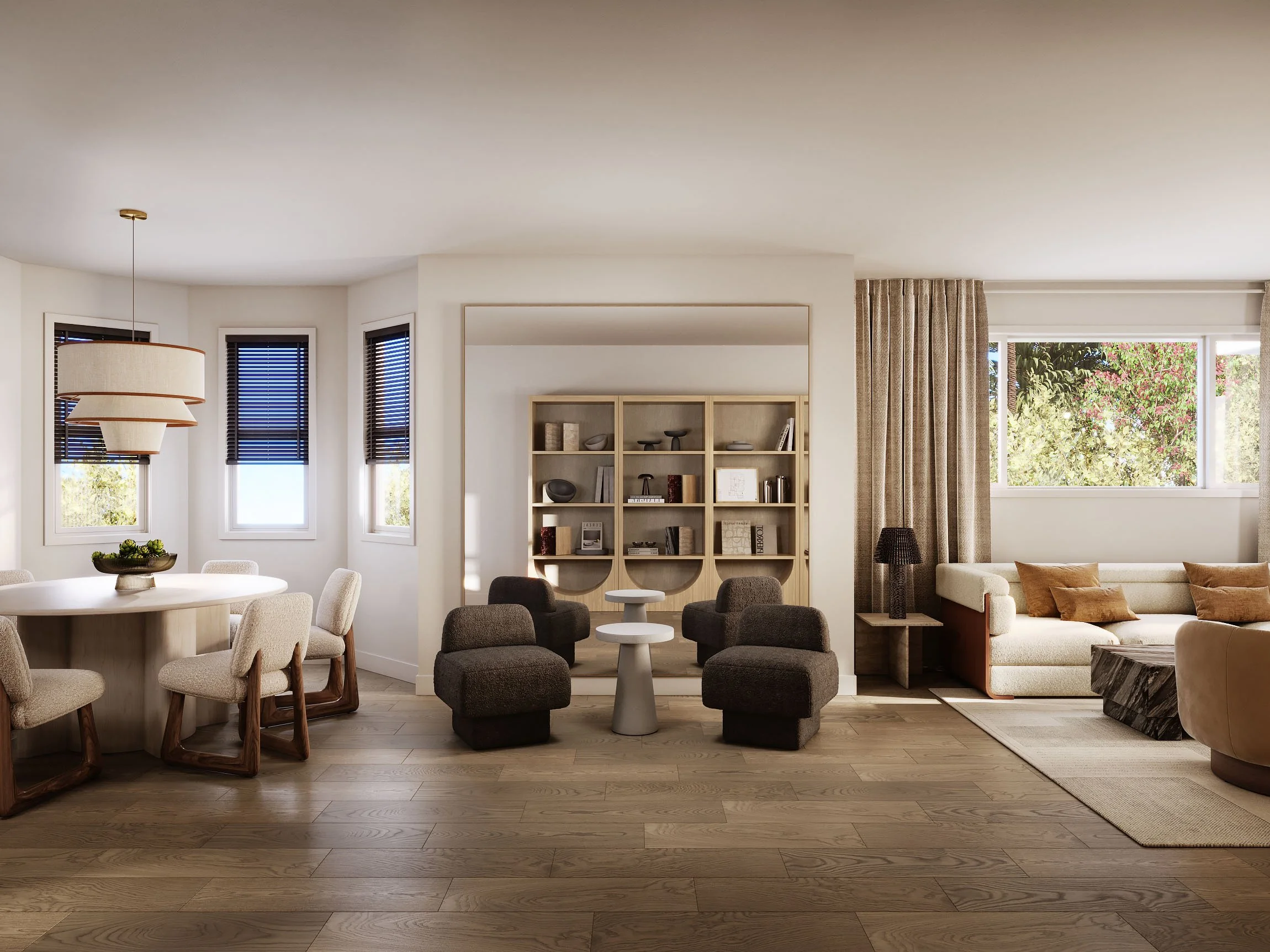 Modern living room and dining area with neutral tones, featuring a round dining table, upholstered chairs, a large sectional sofa, minimalist bookshelves, and large windows with blinds.