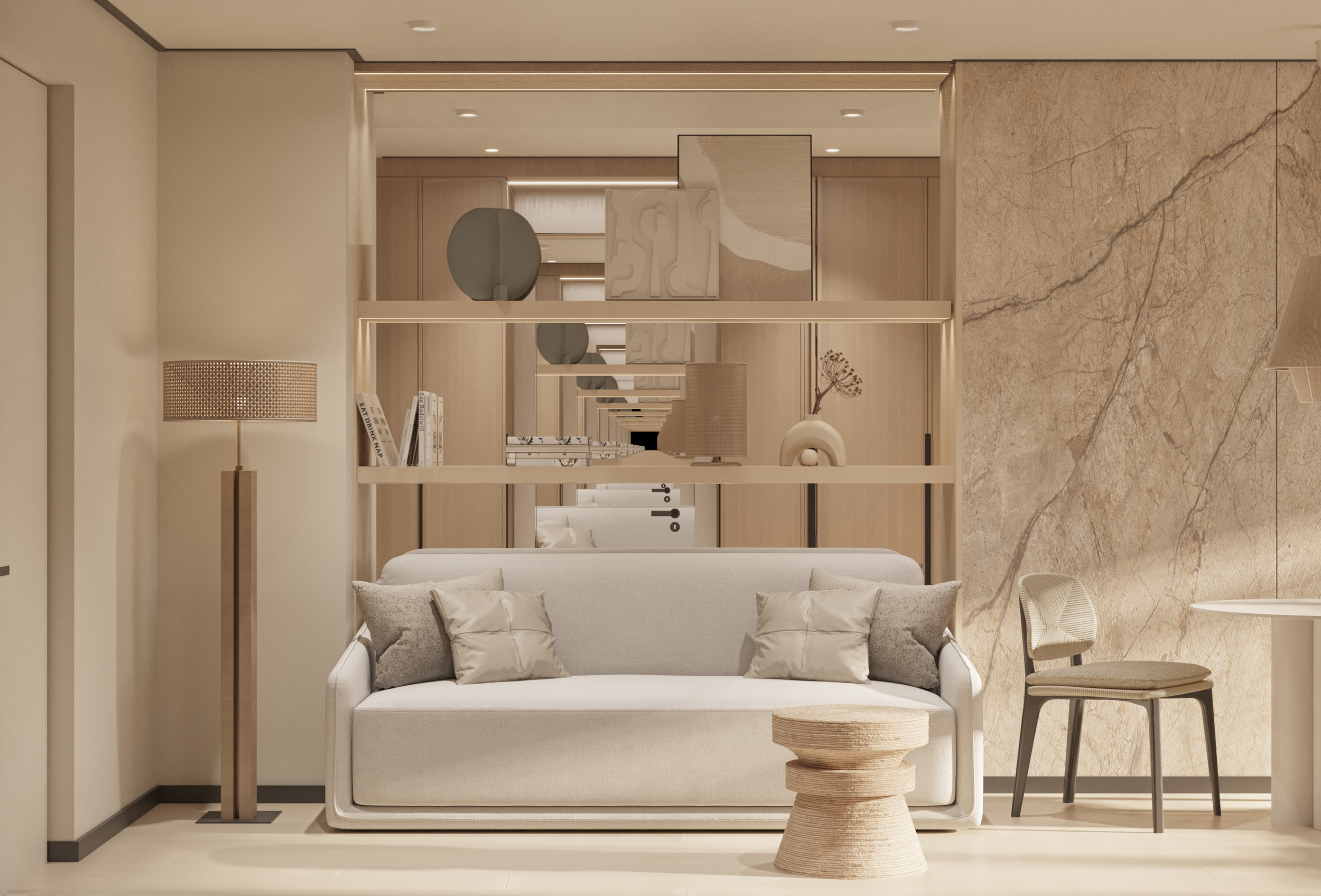 Modern living room with a beige sofa, pillows, and decorative shelves. A wooden floor lamp stands beside the sofa. A wooden chair and small woven table are nearby, with abstract art on the shelves and a textured wall in the background.