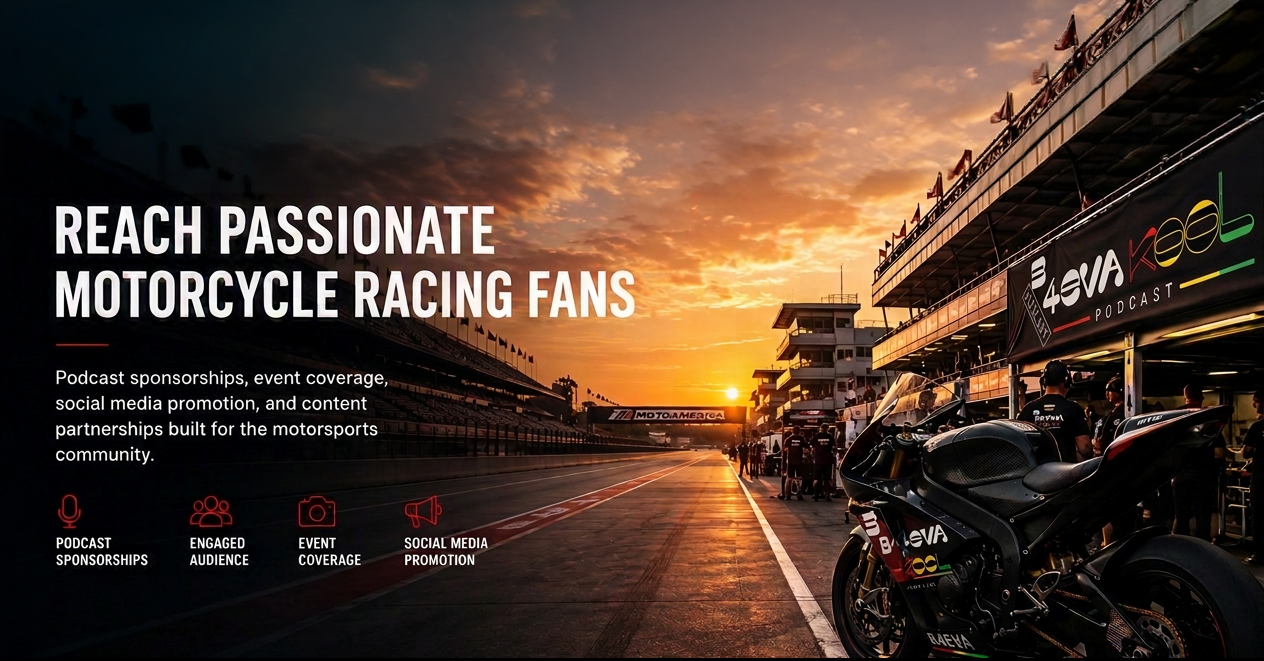 Sunset at a race track with a motorcycle in the foreground and a garage with people, banners, and race cars in the background.