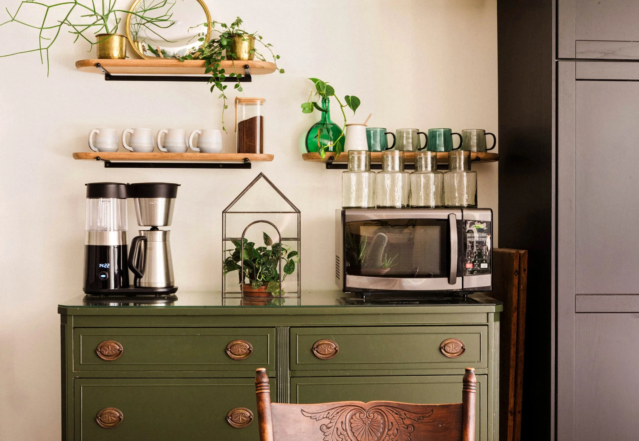 Coffee bar setup featuring a vintage olive green storage cabinet.