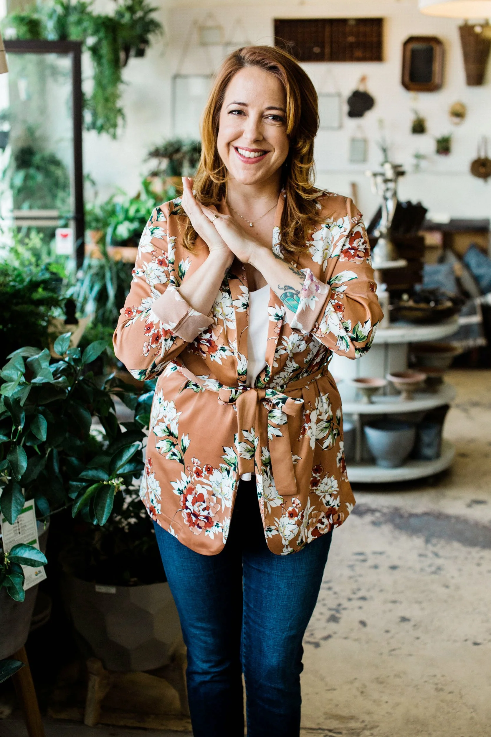 Headshot of entrepreneur Rose Kaz smiling at the camera with her hands joined.
