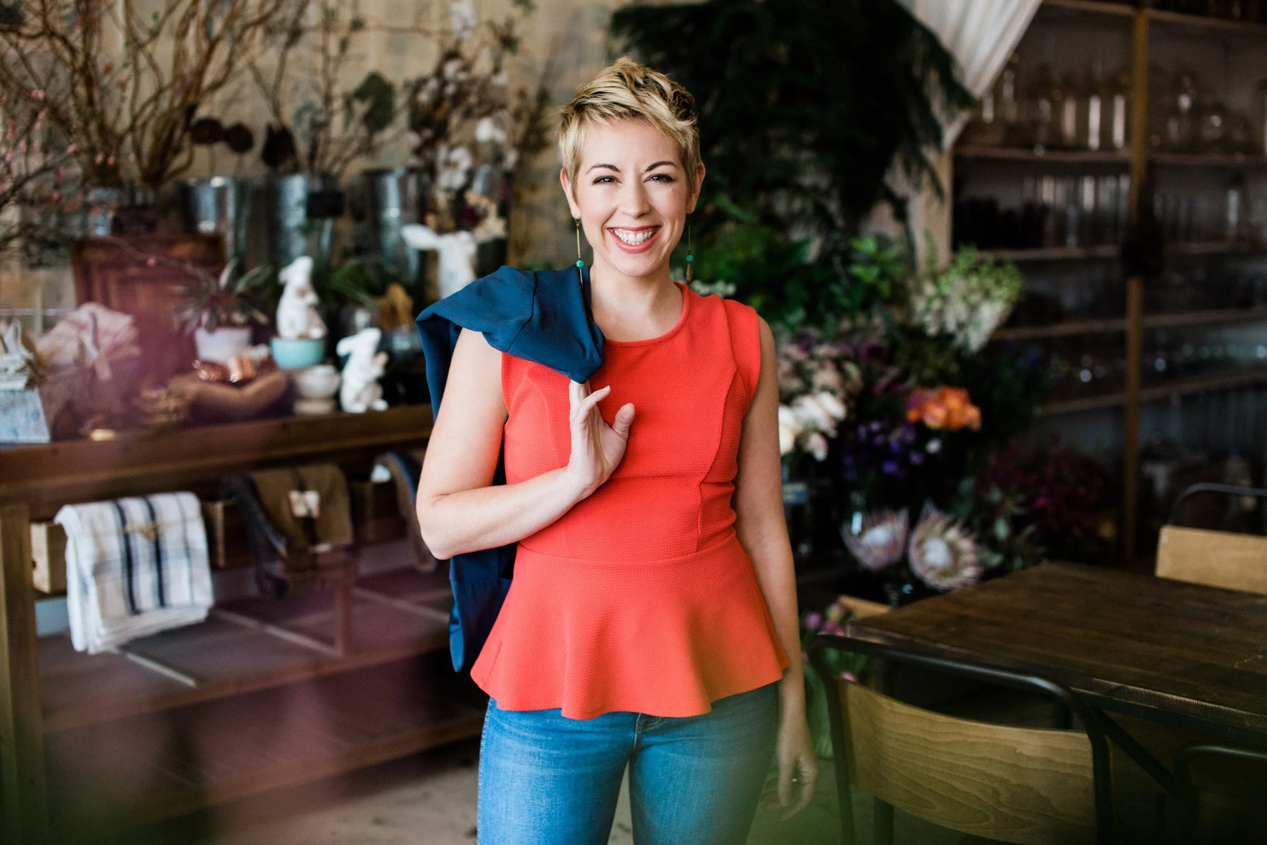 Marisol Colette, Asheville therapist, wearing a red peplum top.