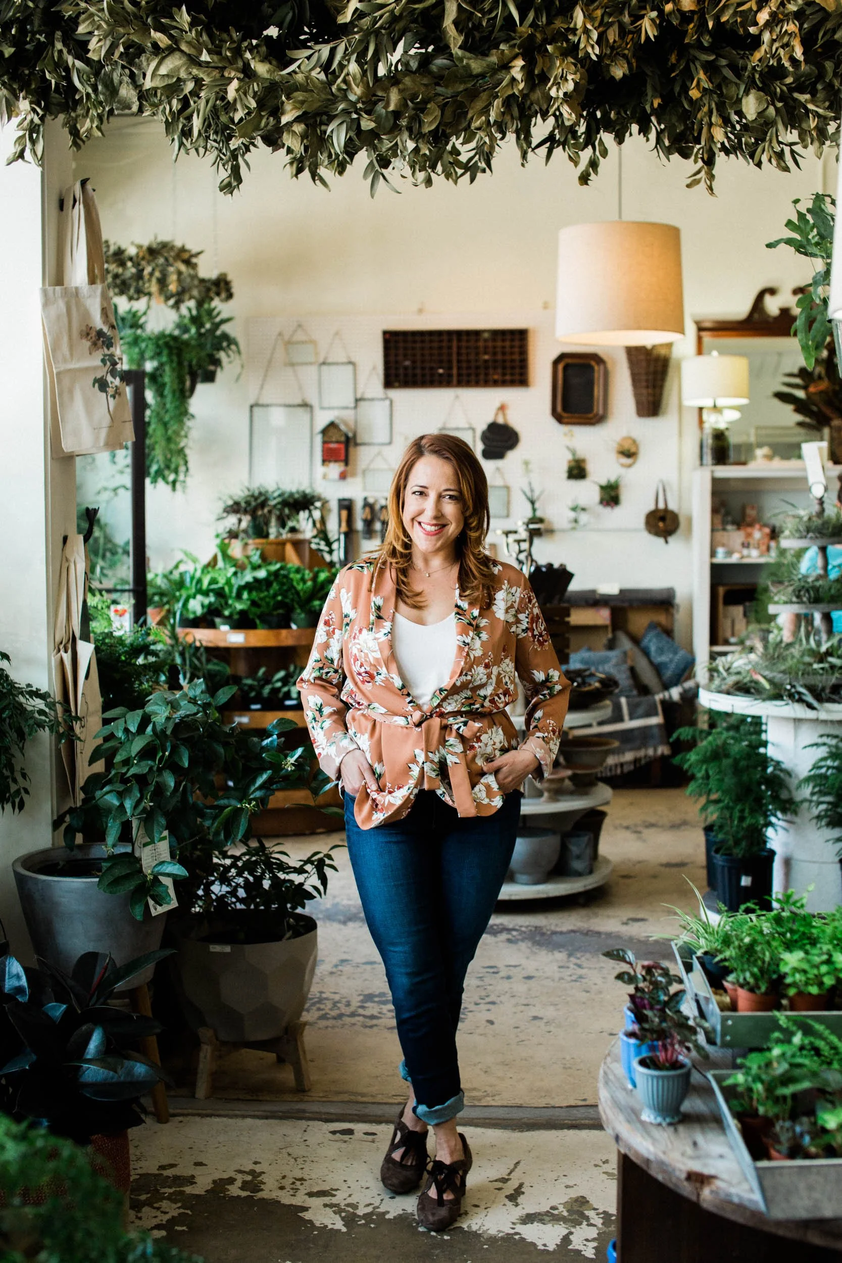 Rose Kaz, founder and entrepreneur, smiling in an inviting boutique setting.