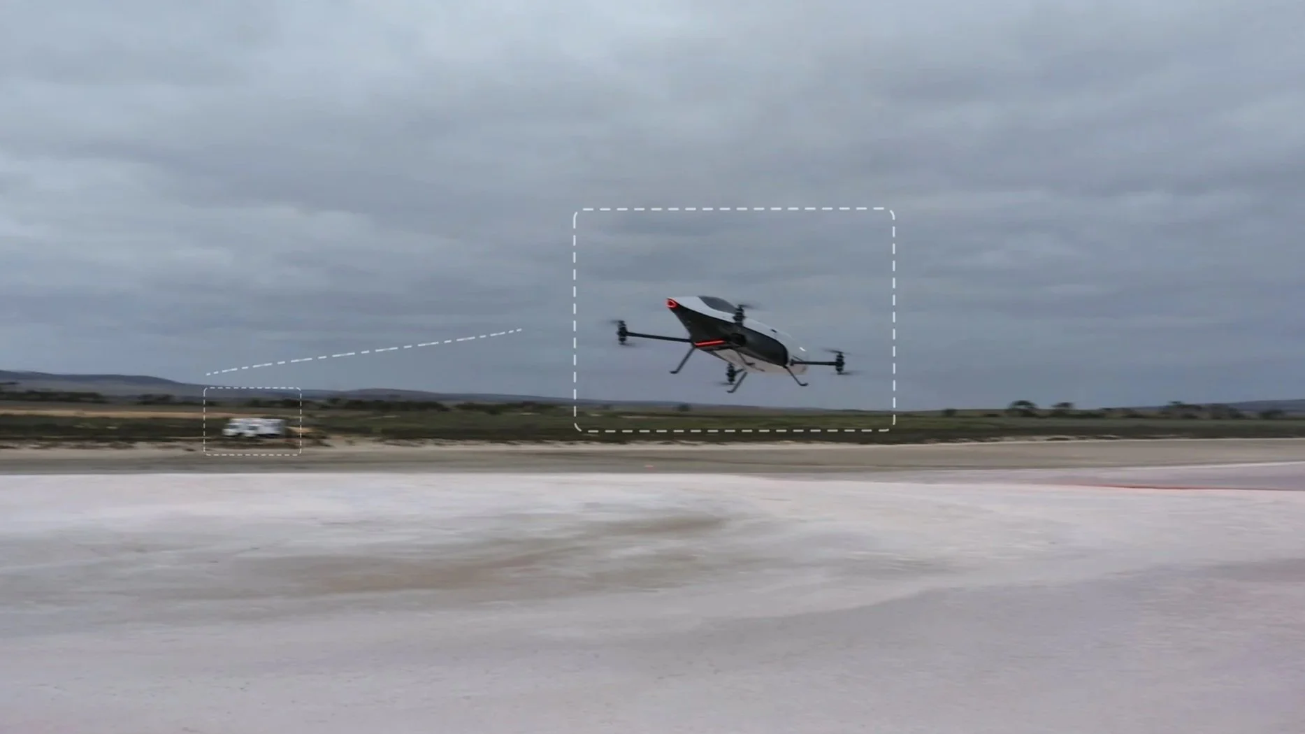 A speeder flying above a runway with a cloudy sky in the background.