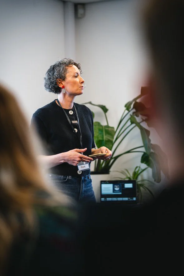 Hope, founder of Attuned Leadership, speaking at a leadership and team development event