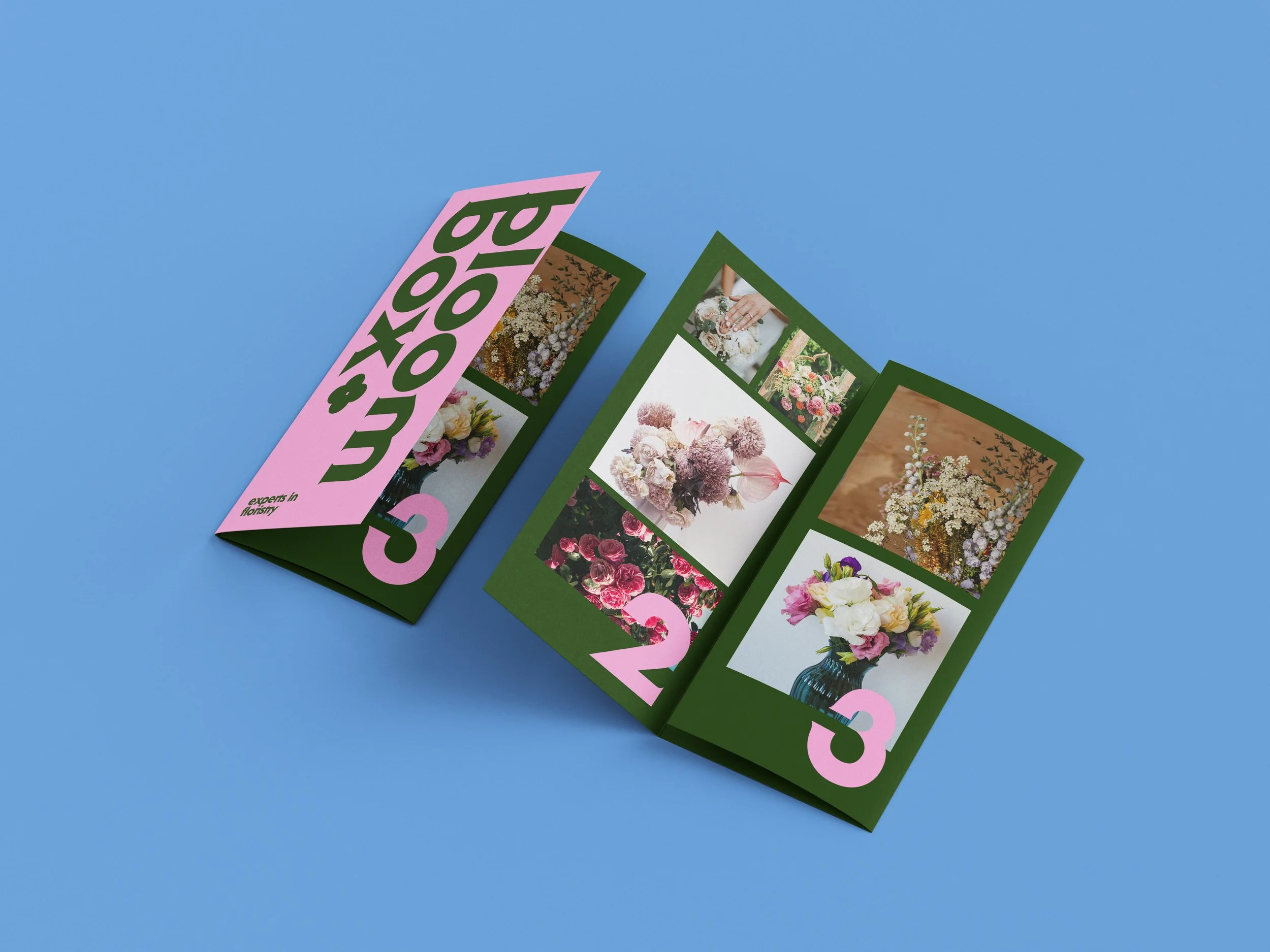 Double sided folded leaflets for a flower company, the leaflets are dark green with pink accents and large text and images.