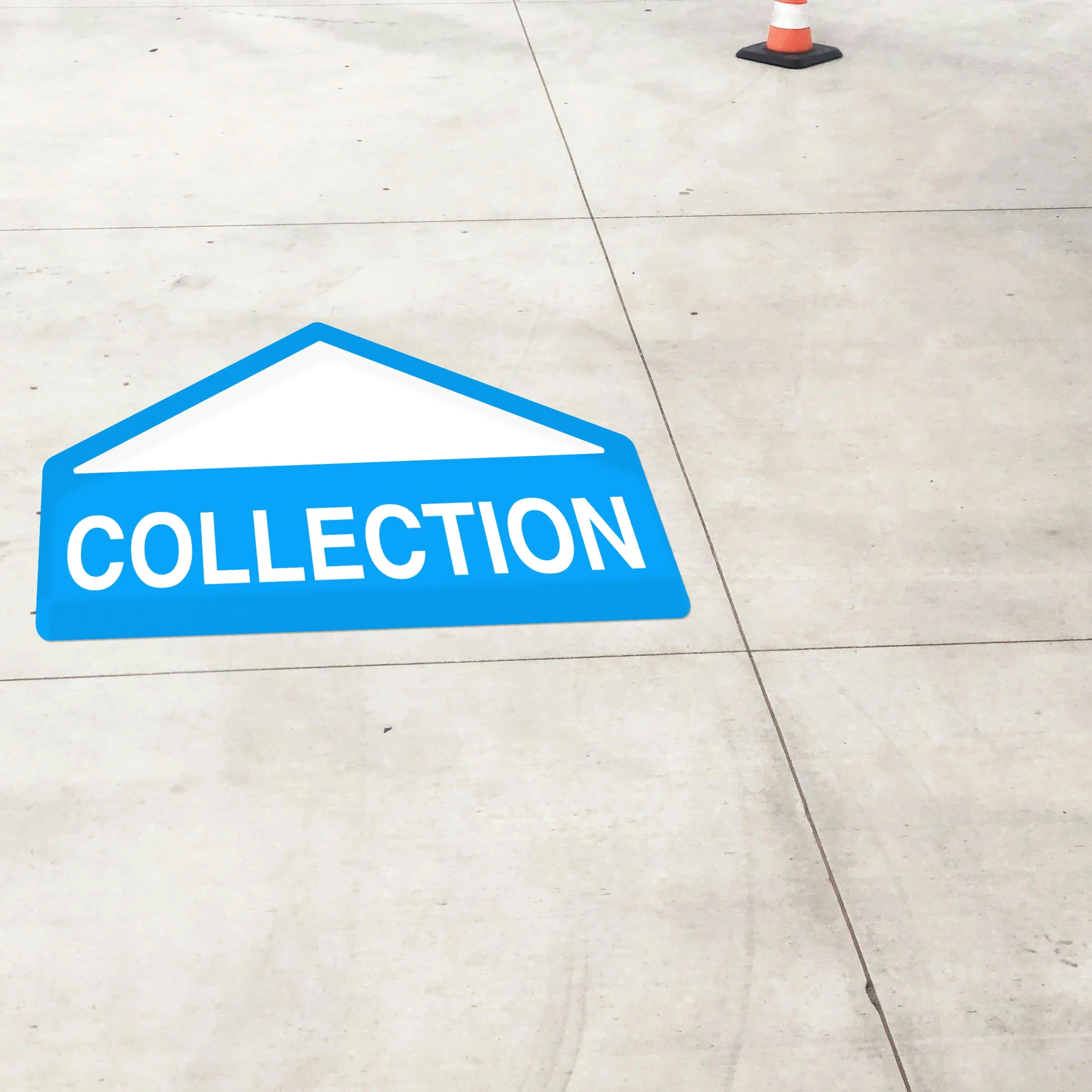 Concrete surface with a cyan floor sticker that reads 'collection' and an orange traffic cone in the background