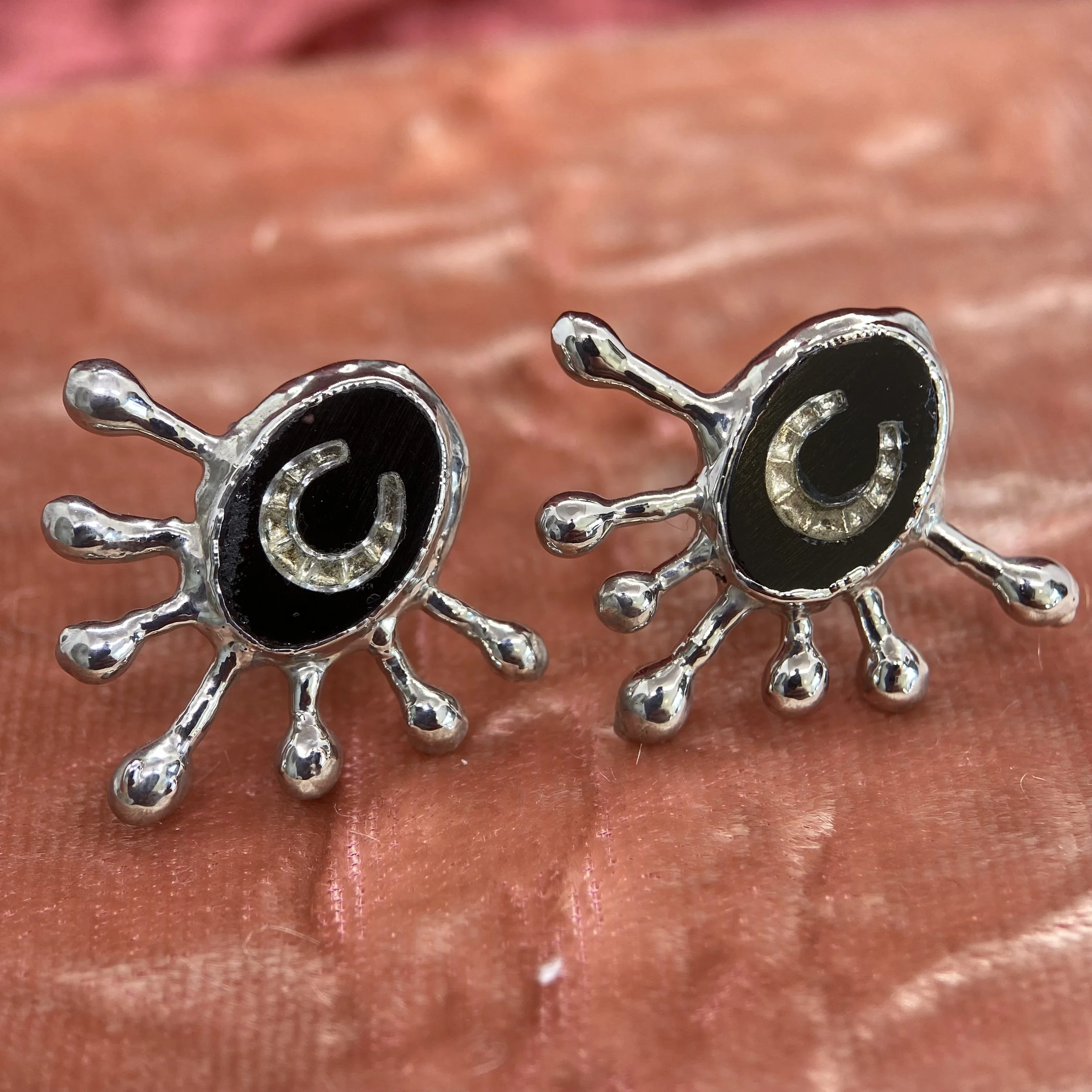 Handmade palladium-plated earrings with black 1930s vintage glass cabochons inlaid with silver-tone horseshoes, mounted in unique "drippy" bezels.