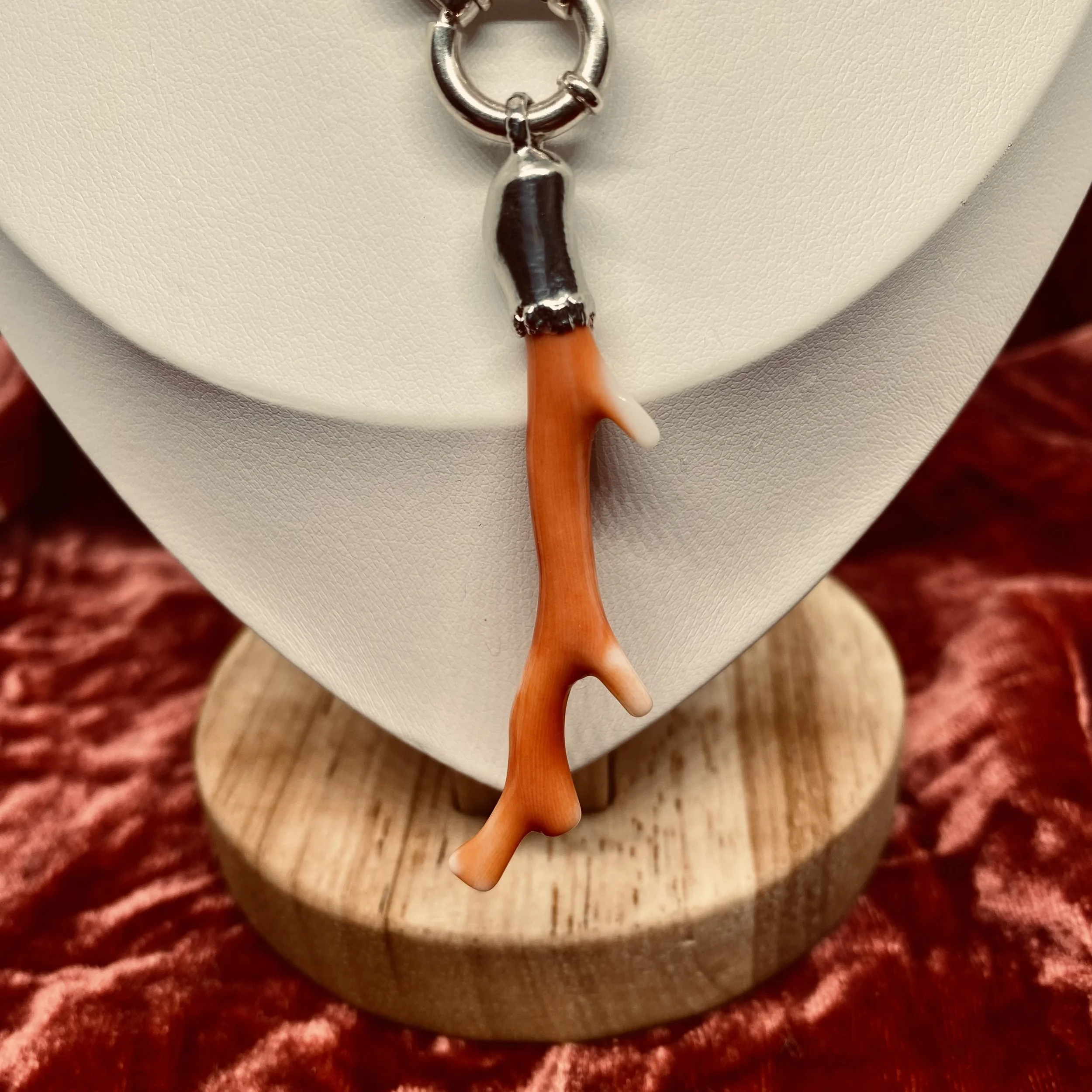 detail shot of silver bolt ring clasp with large, pink, Japanese deep sea coral pendant