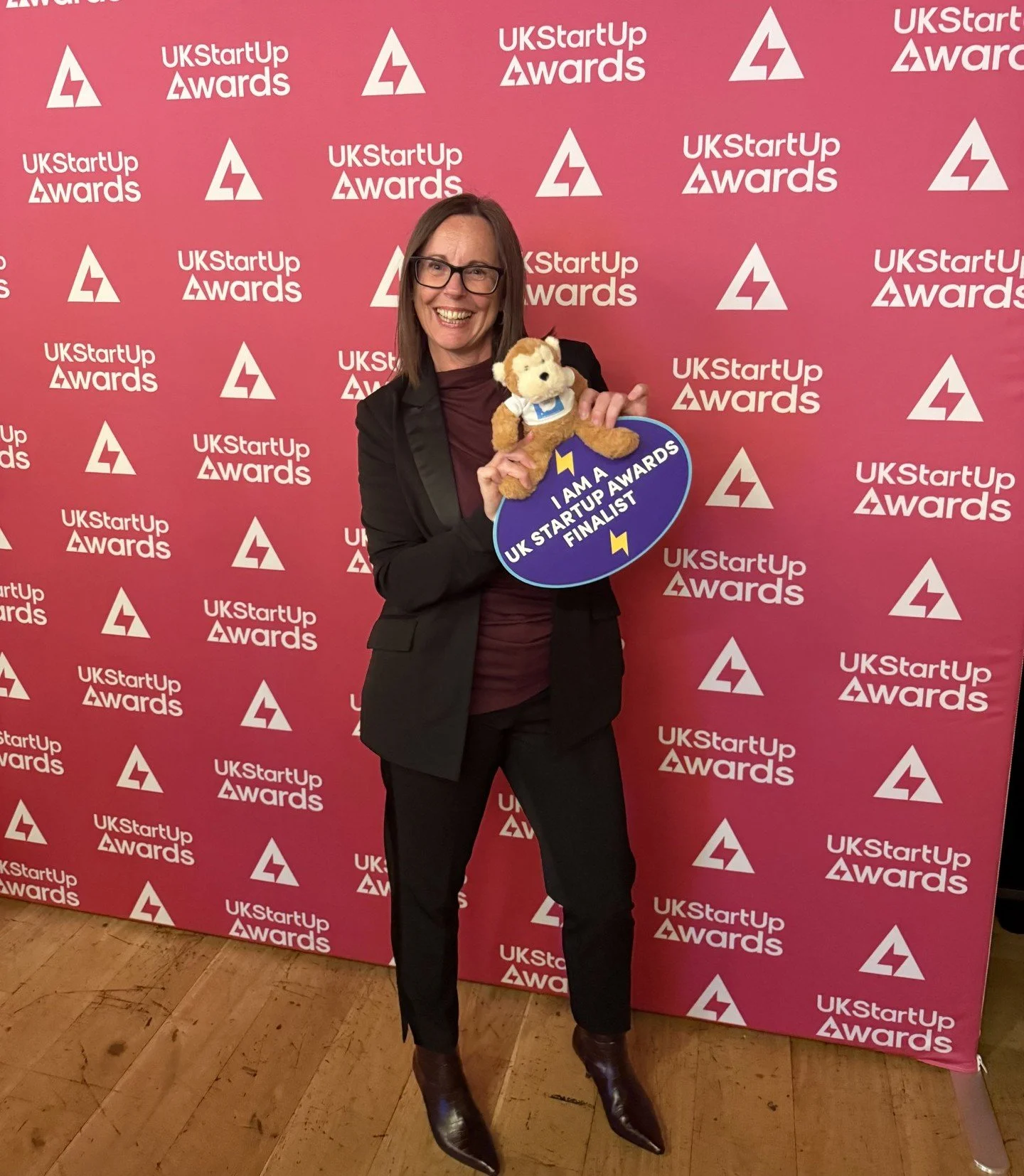 Vicky Mose, founder of Imagine How, holding the Menopause Monkey and a finalist sign at the UK StartUp Awards 2026.