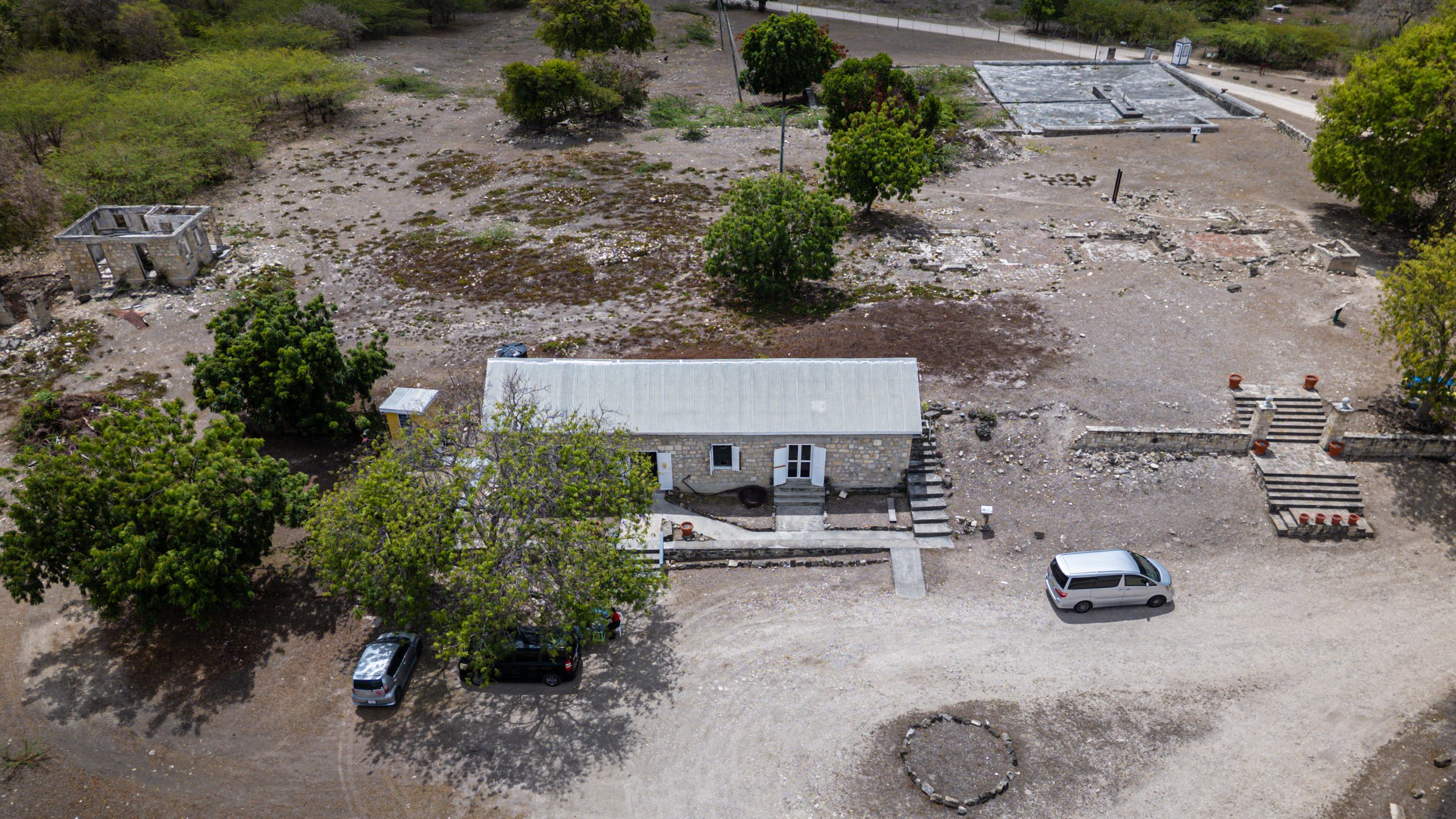 Visitor Center housed in a converted former cotton storeroom, Great House footprint, the estate master's residence situated on a slight elevation overlooking the production zone , cistern complex, four deep, interconnected stone rainwater catchment b