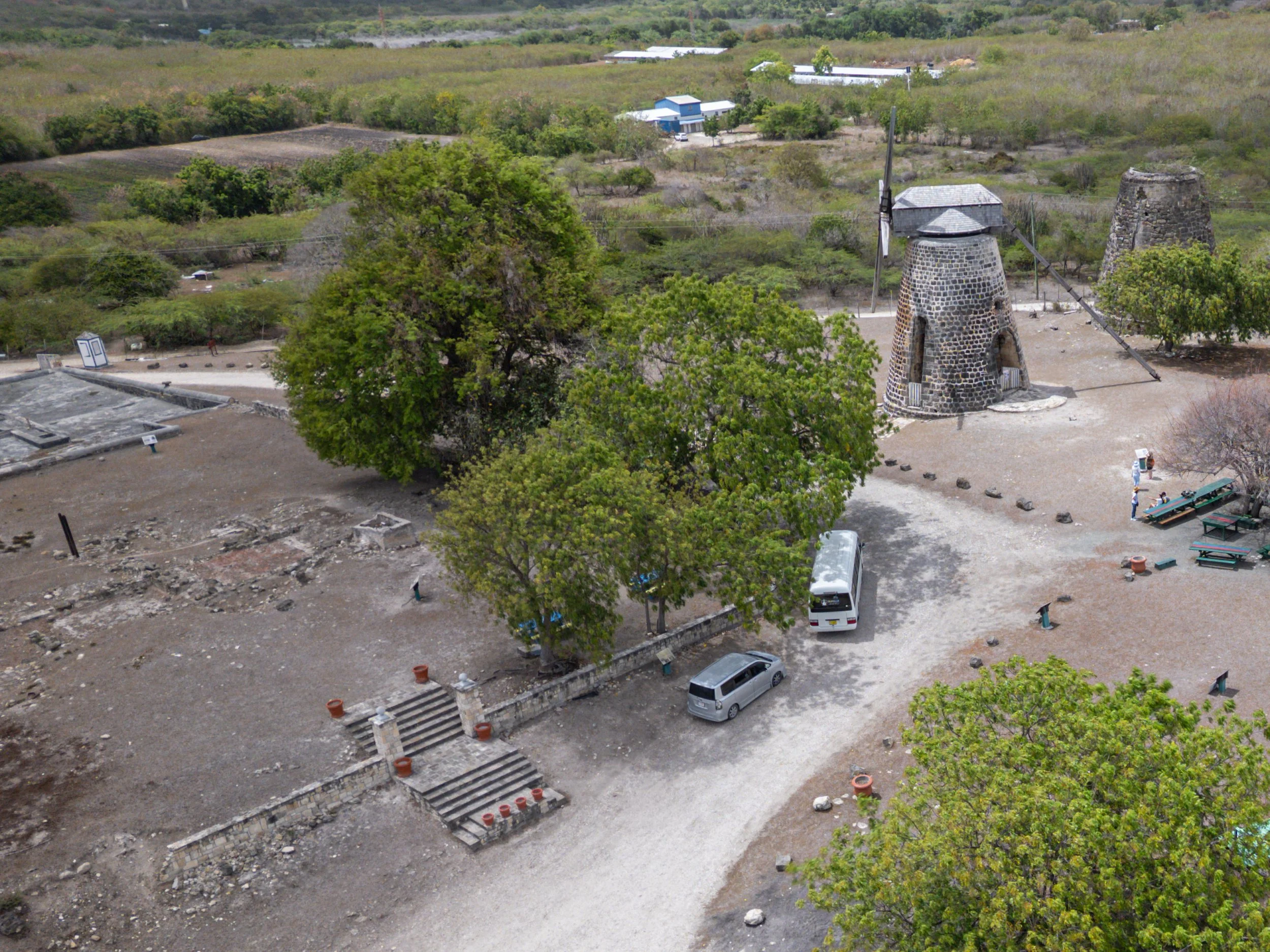 Great House footprint of structure destroyed by fire in the 1930s, cistern complex in back and new and old windmills