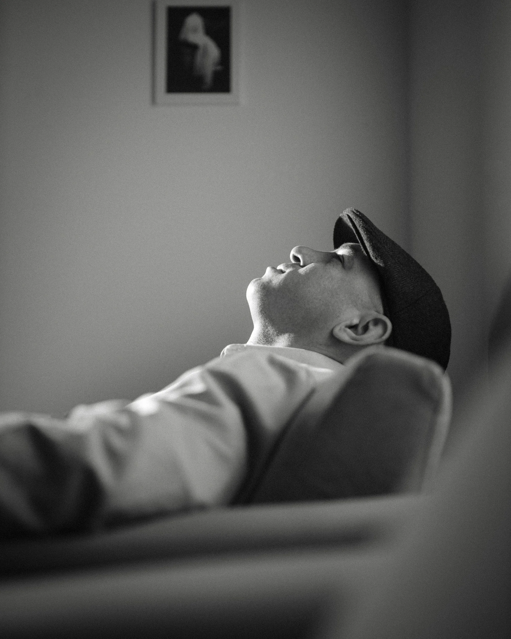 A man sitting in his therapy session with a concerned face