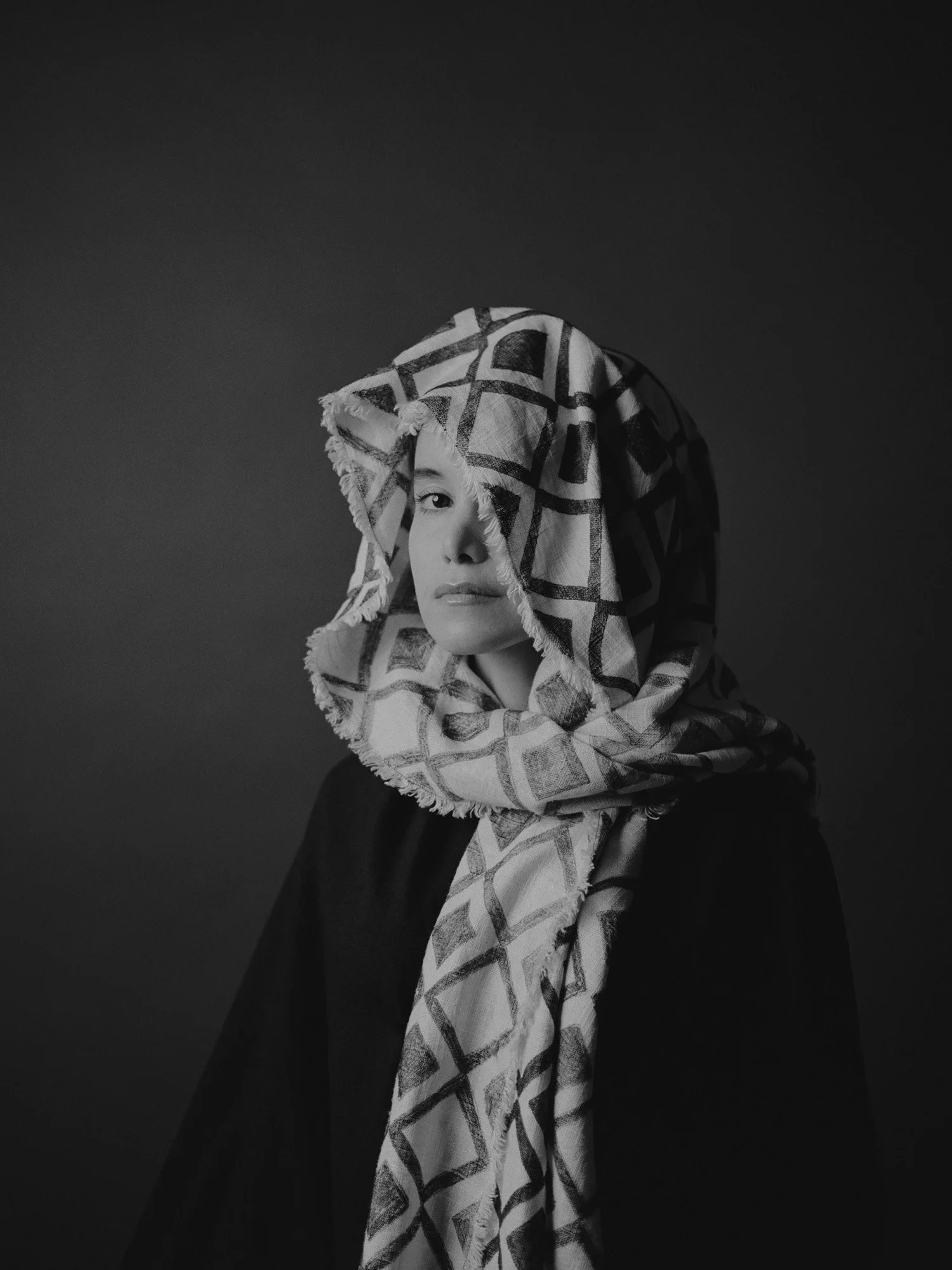 A black and white portrait exploring intimacy, texture, and soft light through a simple and contemplative composition.