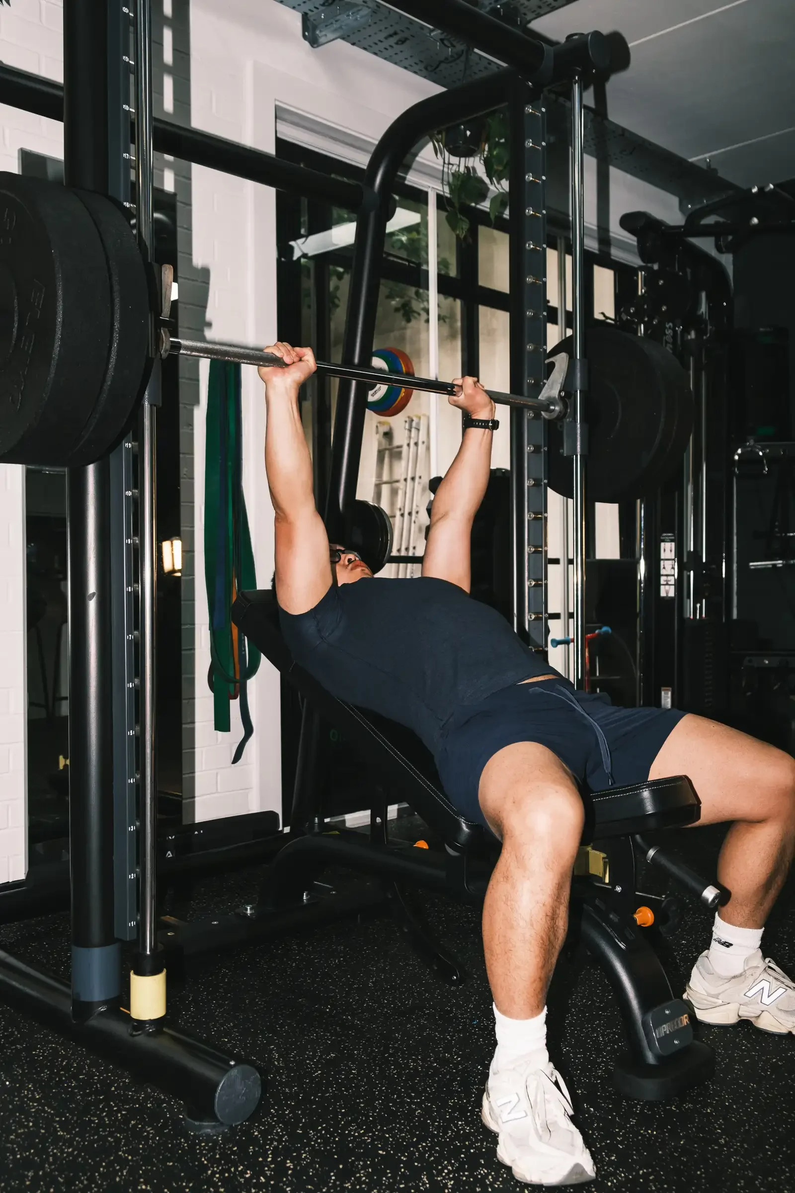 Alexander doing Inclined Bench Press movement in the studio