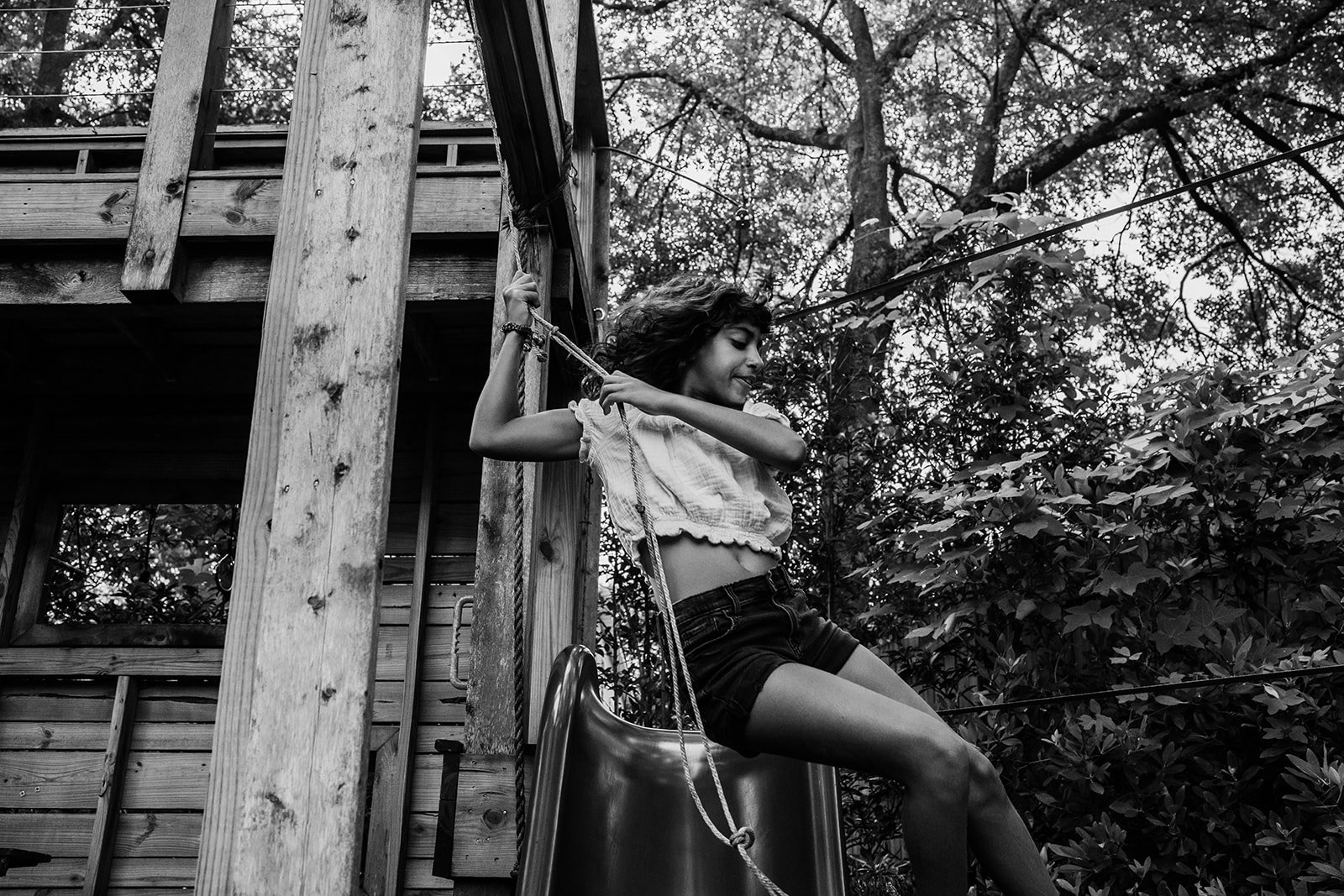 Teenager swinging on a rope swing