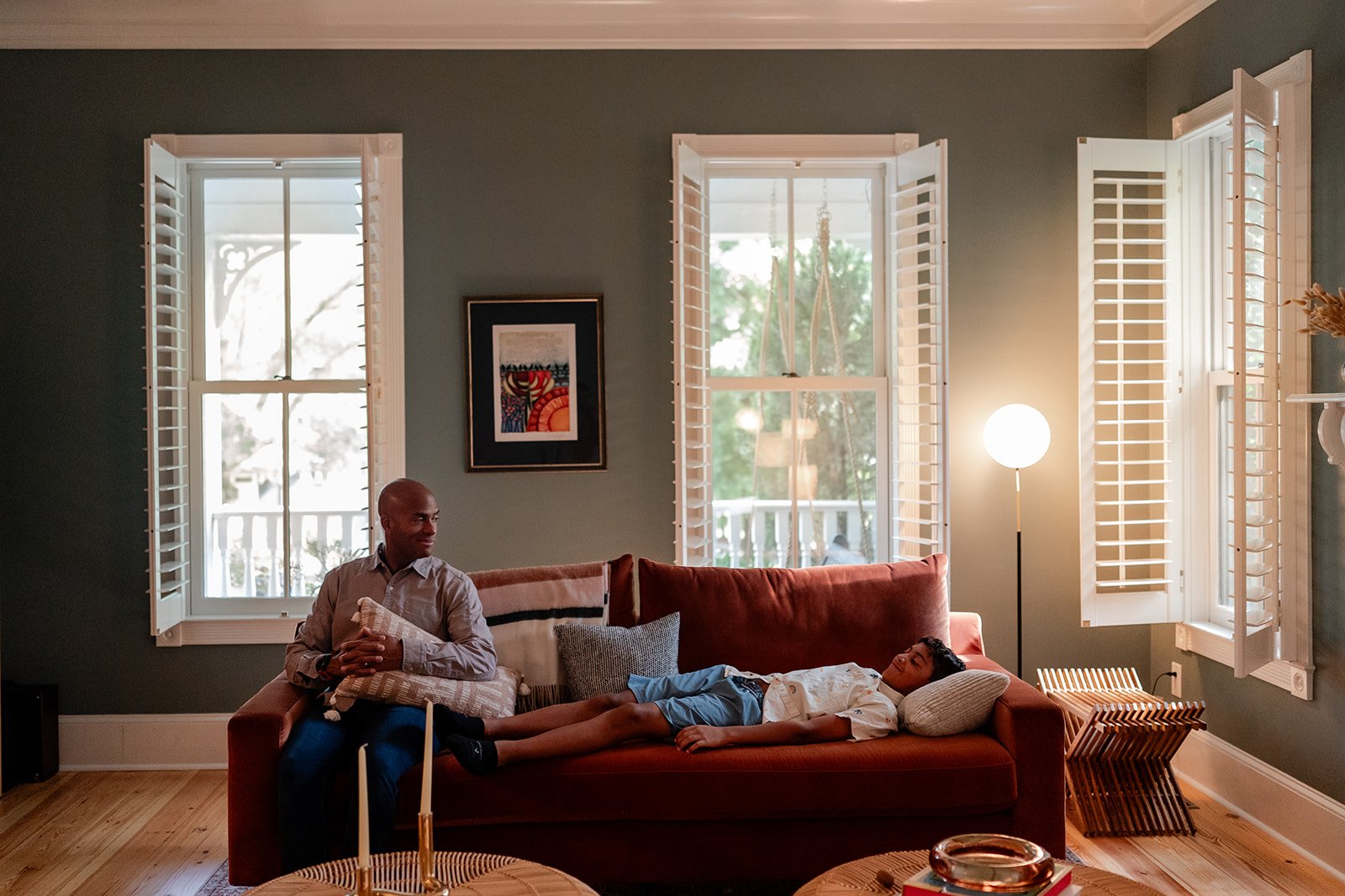 Dad and son hanging out on a couch at home