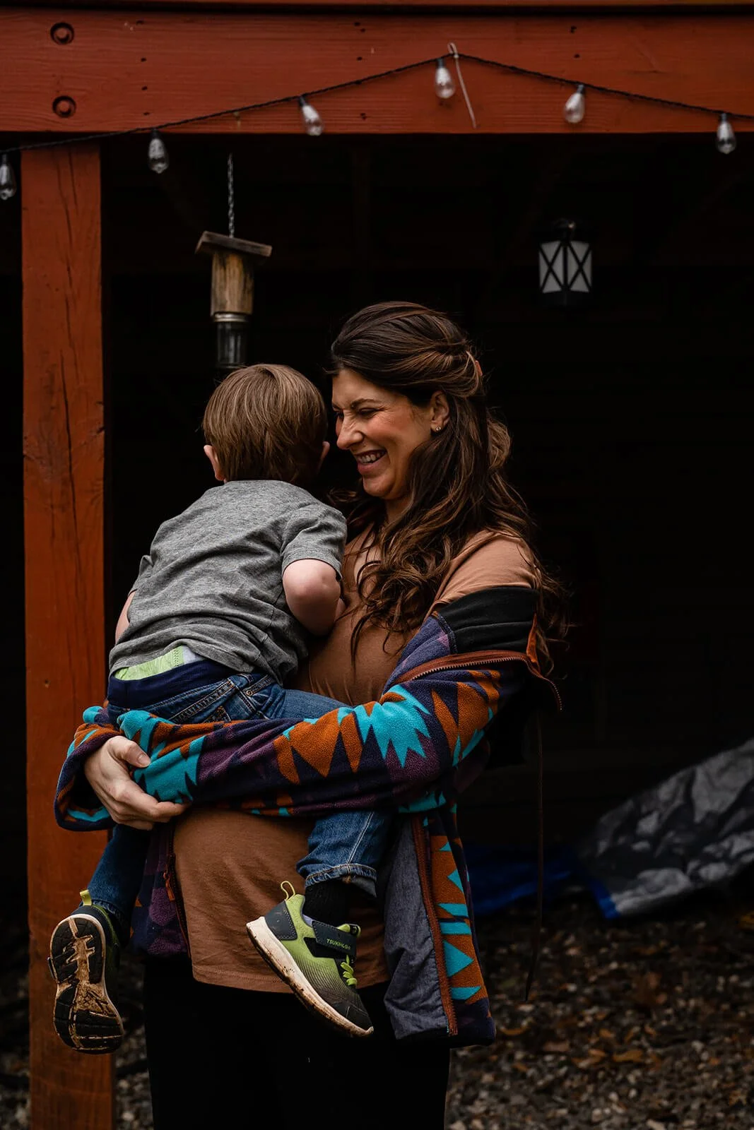 Pregnant mother hugging her toddler in their Decatur backyard