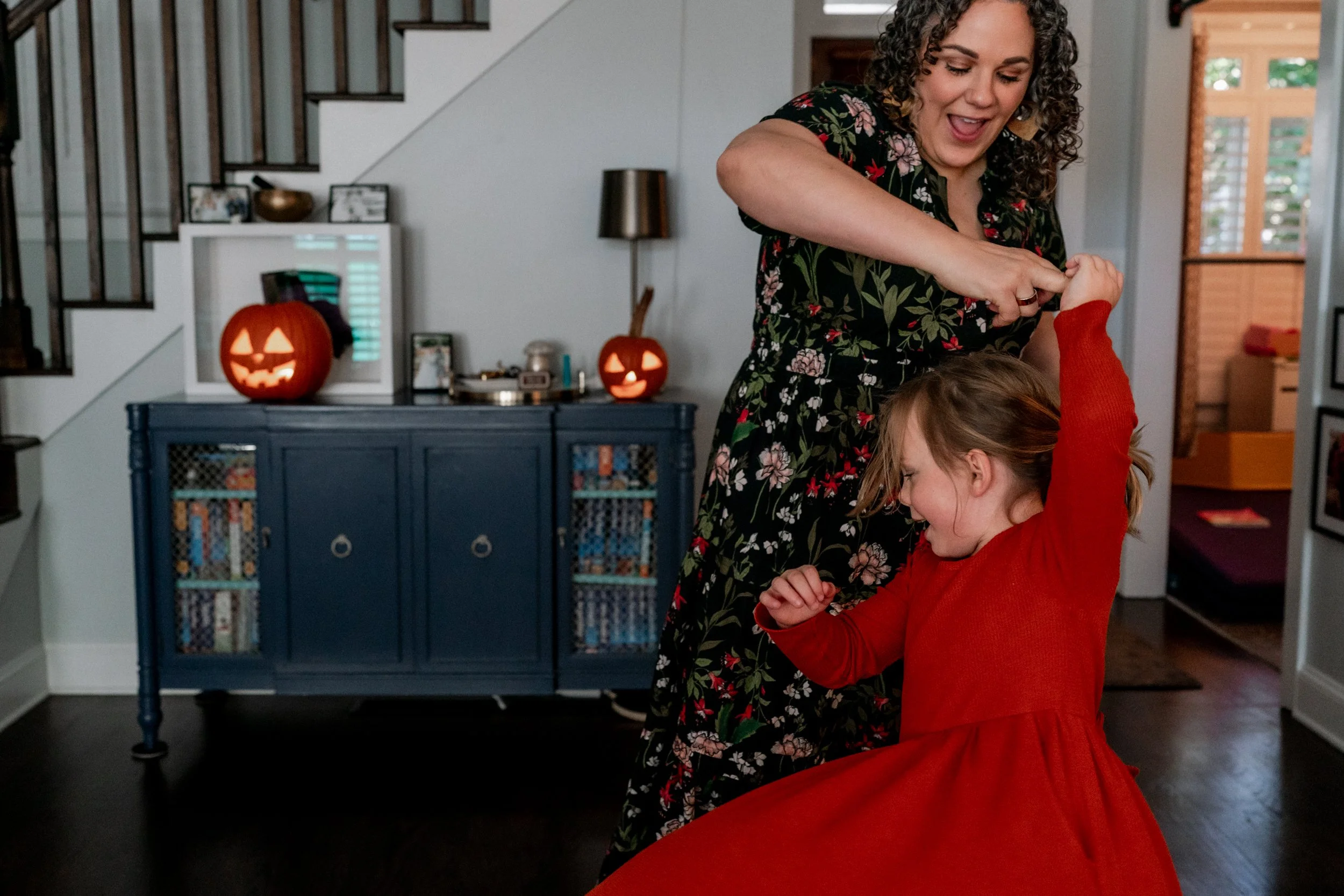 Mom dancing with her daughter at home
