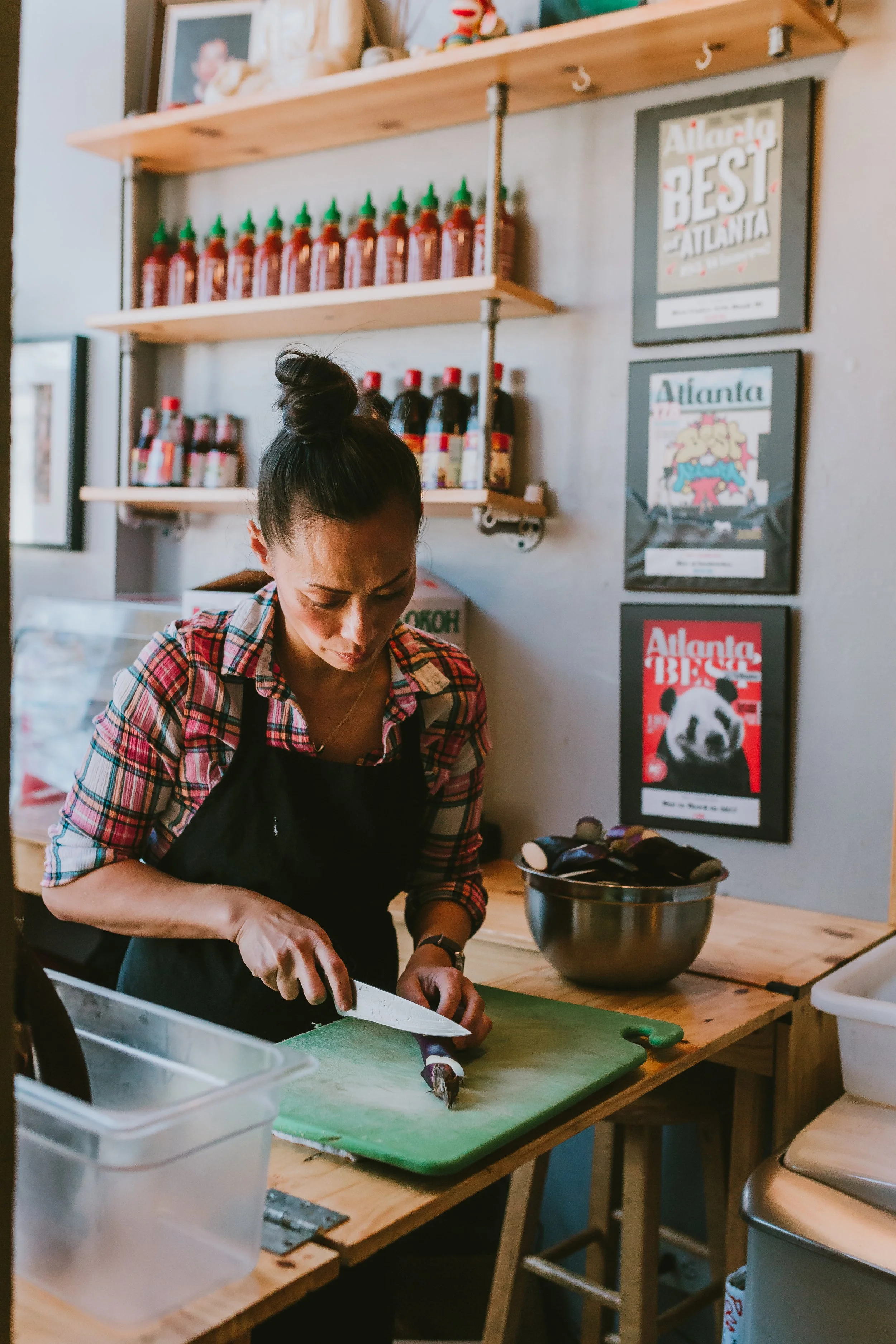 Woman chopping veggies in an East Atlanta restaurant