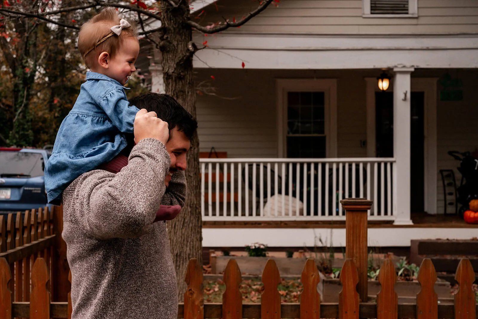 Dad carrying his baby daughter on his shoulders