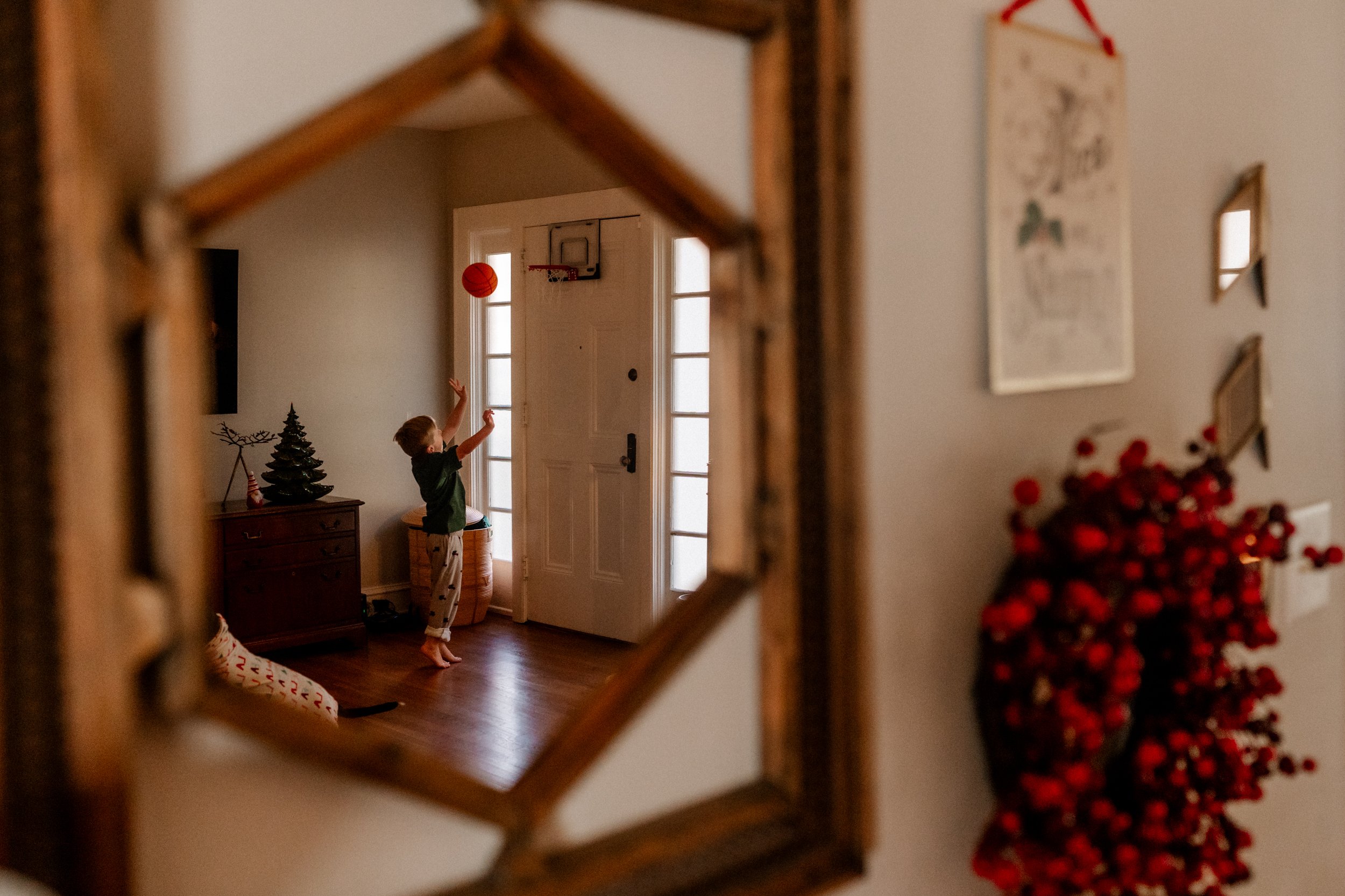 Boy playing basketball in his jammies in the living room