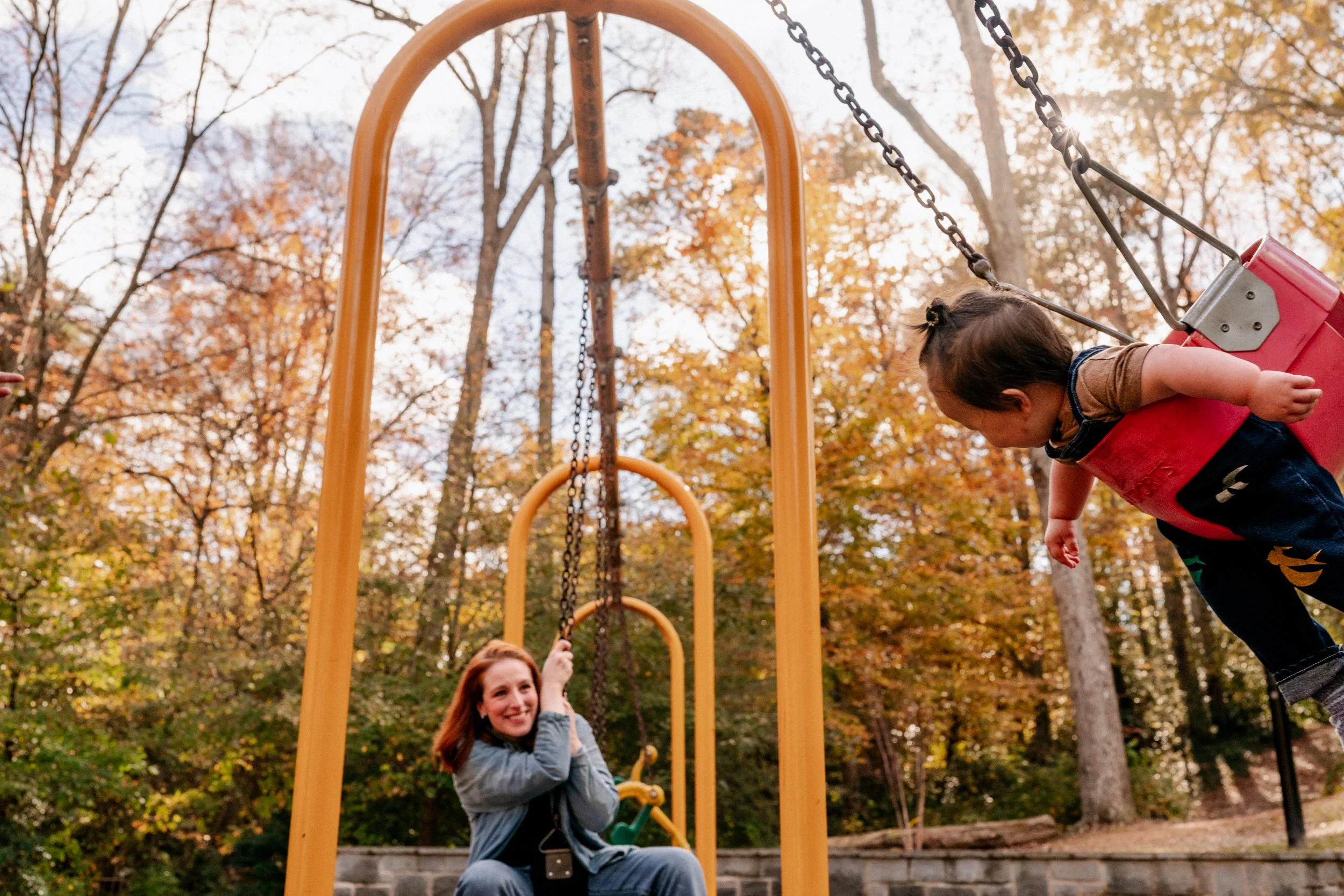 Mother and daughter at Lake Claire Park on the swings