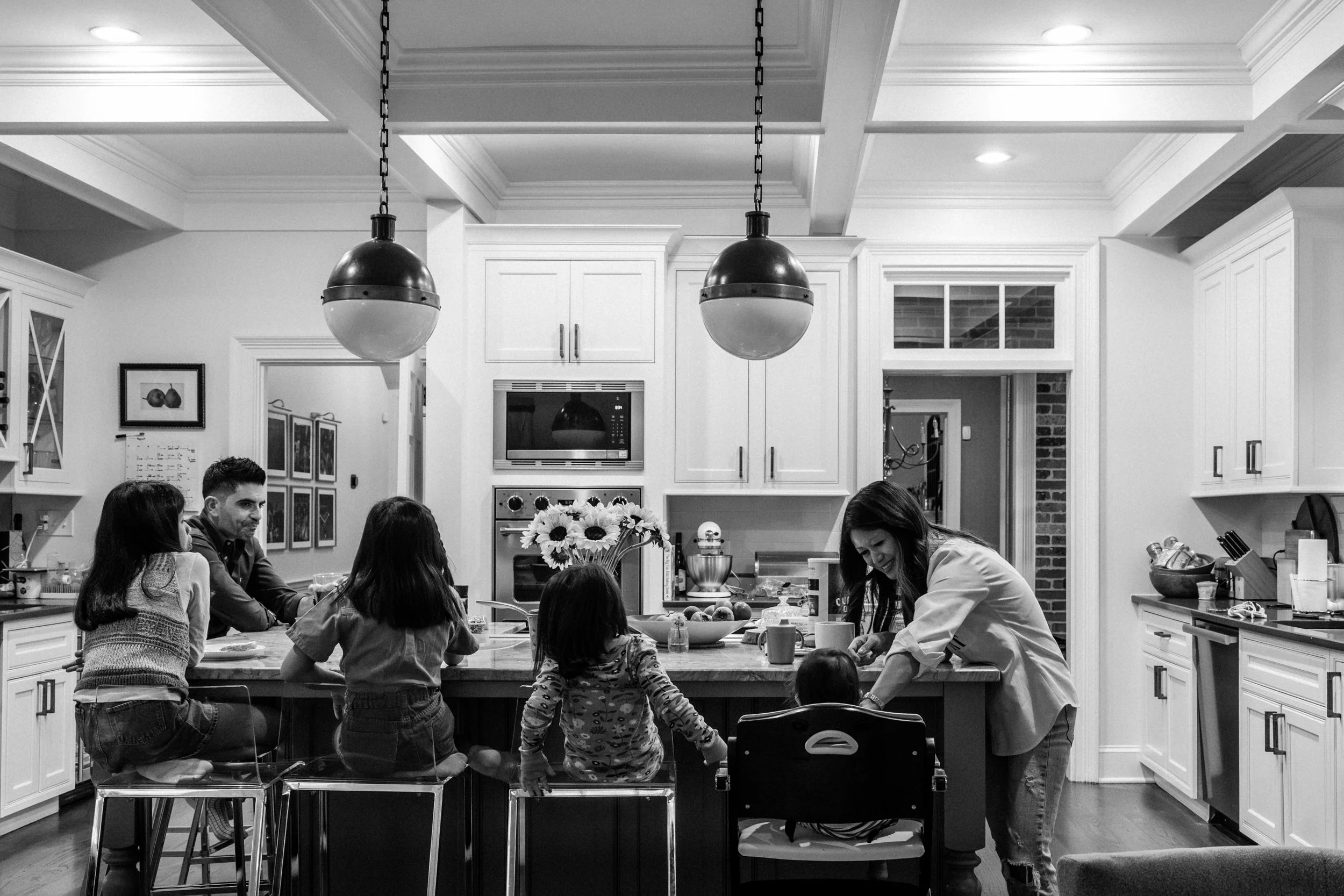 Family eating breakfast in their kitchen at home in Ansley Park Atlanta