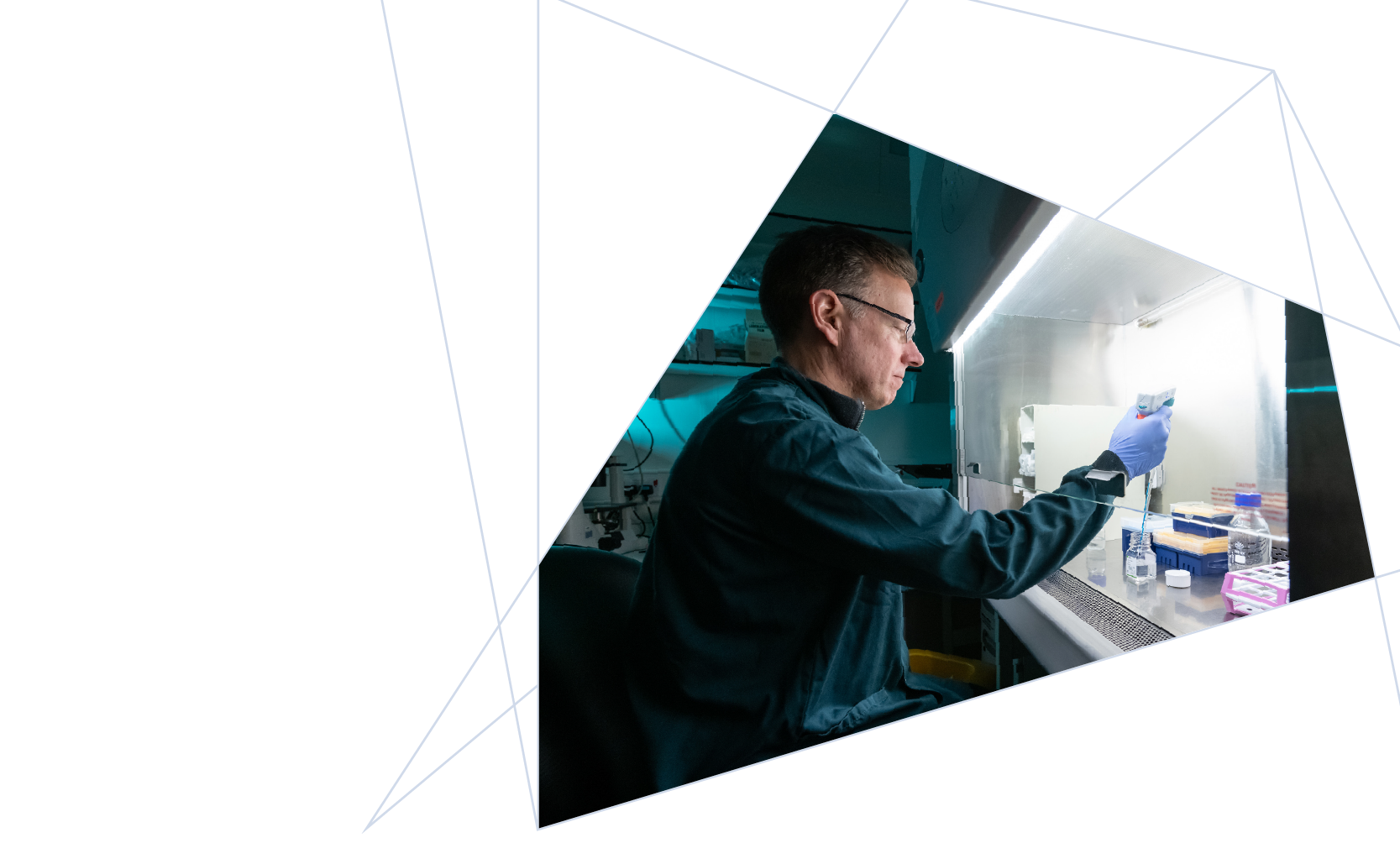 A scientist working in a laboratory, using a pipette to handle samples inside a biosafety cabinet.