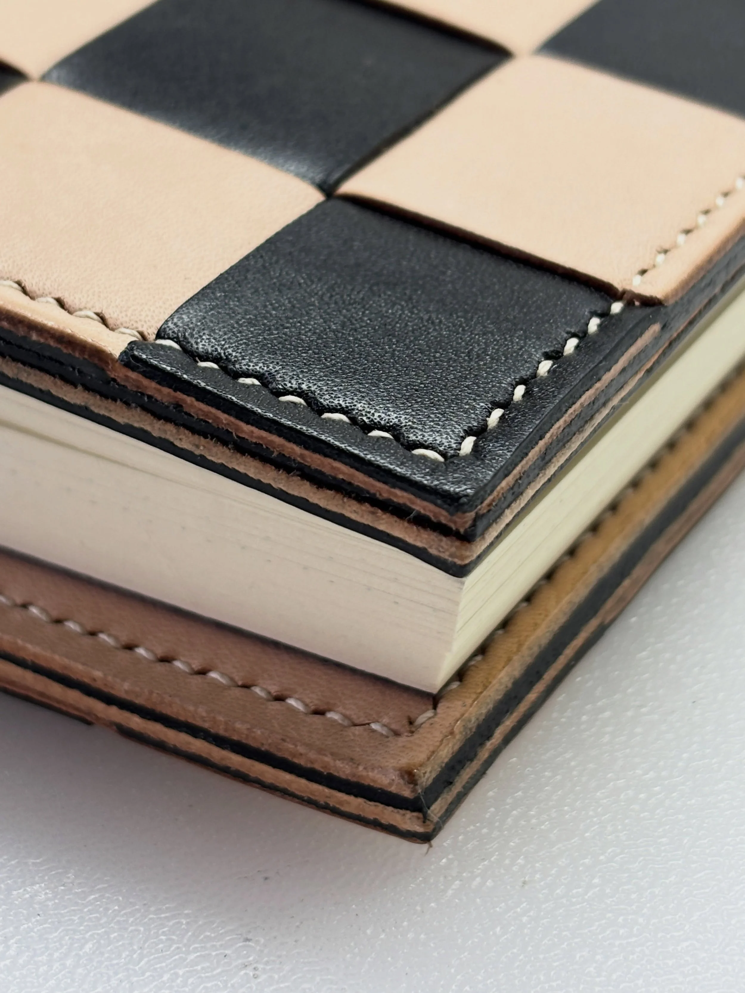 A closer look at my latest journal commission for an A5 bifold journal in soft, checkerboard-weaved calf leather. 

Lined with cowhide and finished with contrast pockets, the natural veg tan leather will patina into a beautiful, rich caramel colour a