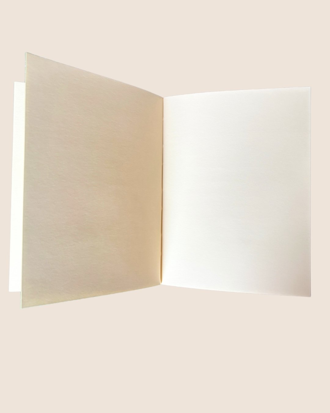 Close up view of an A5 notebook journal refill on a cream background