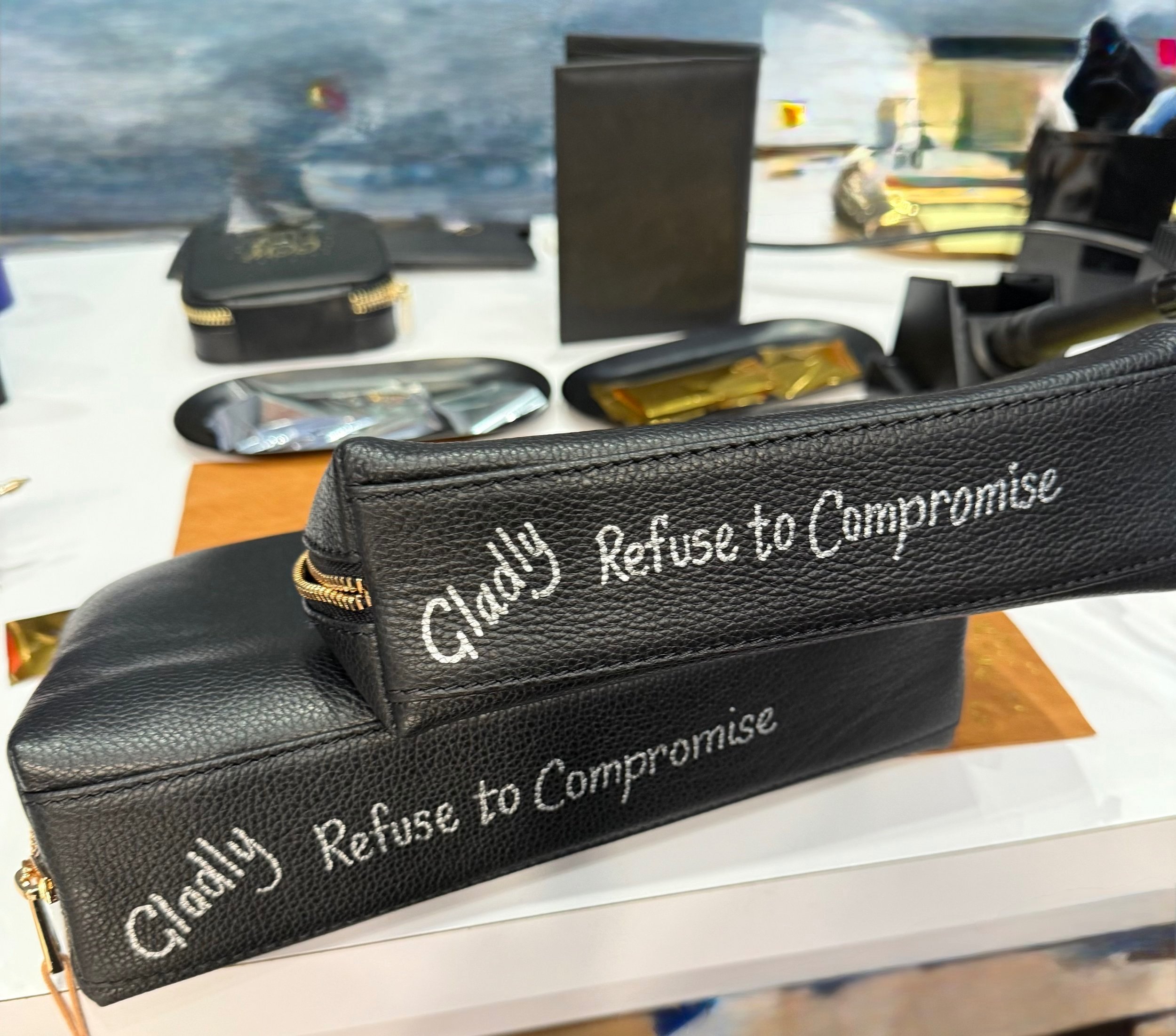 Calligraphy by Susan Houseman Designs on leather bags.