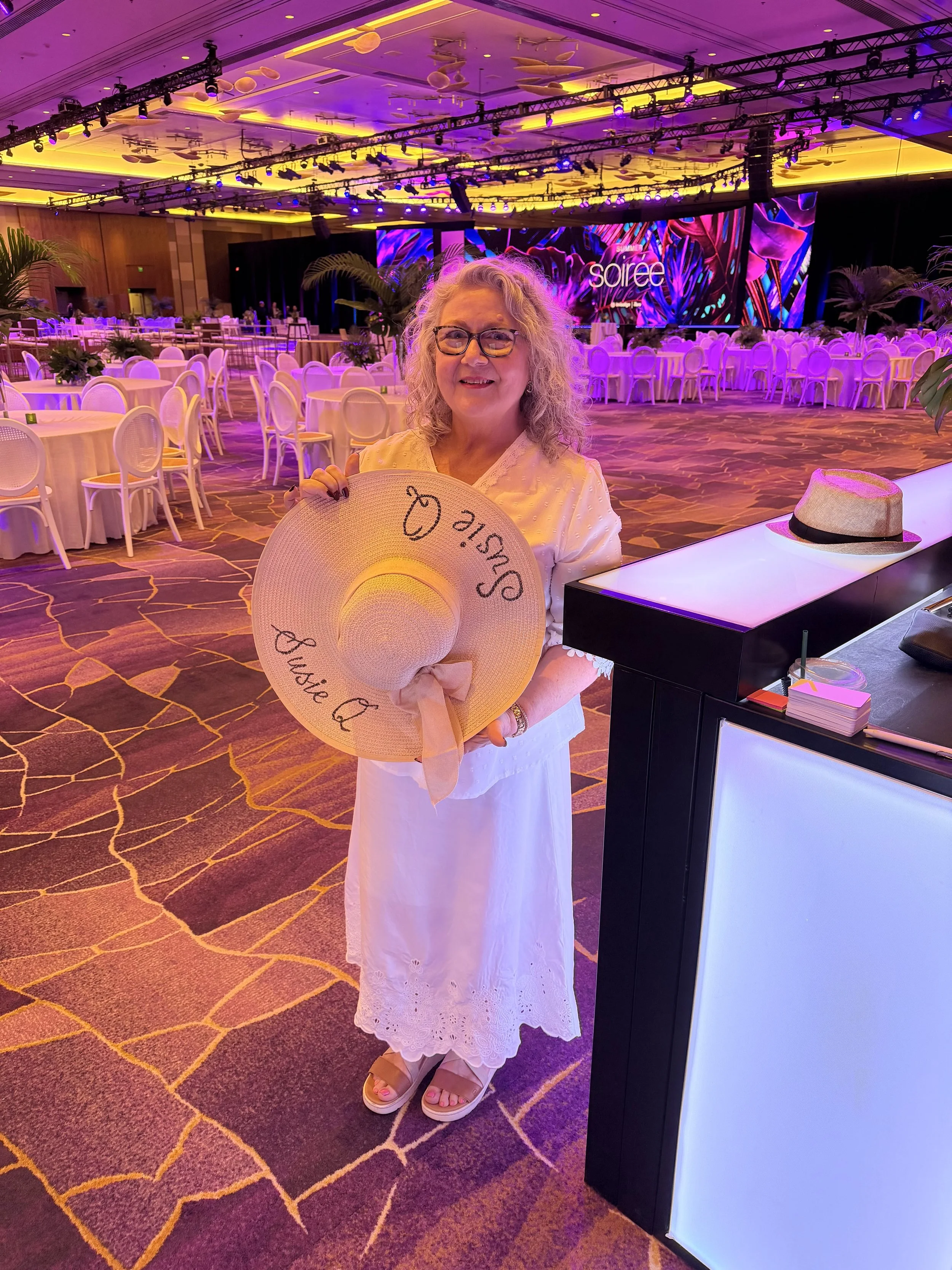 Susan Houseman Designs providing calligraphy on Fedoras, and Sun Hats for a corporate event.