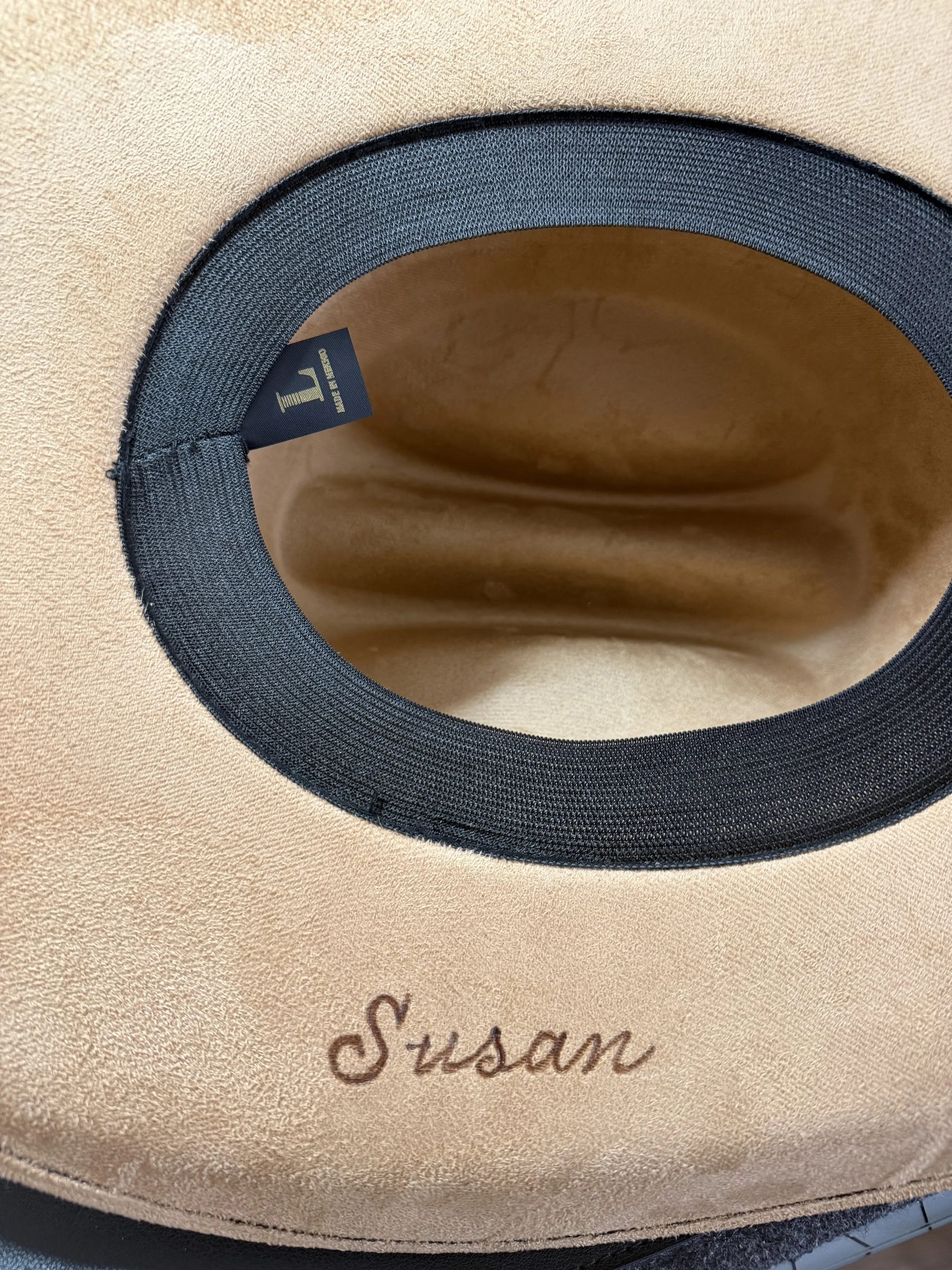 Susan Houseman Designs is personalizing cowboy hats.  The technique is pyrography.