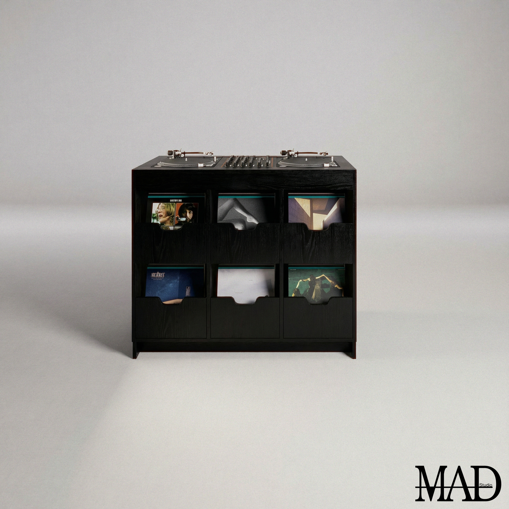 A black wooden record storage unit with multiple compartments, holding vinyl records, and a DJ turntable on top. The background is plain and light-colored. The MAD Studio logo is in the bottom right corner.