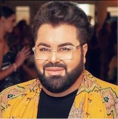 Pedram Pasha Taheri
Fashion Designer
Pedram Couture A man with a beard and glasses, wearing a colorful patterned shirt, smiling at the camera.