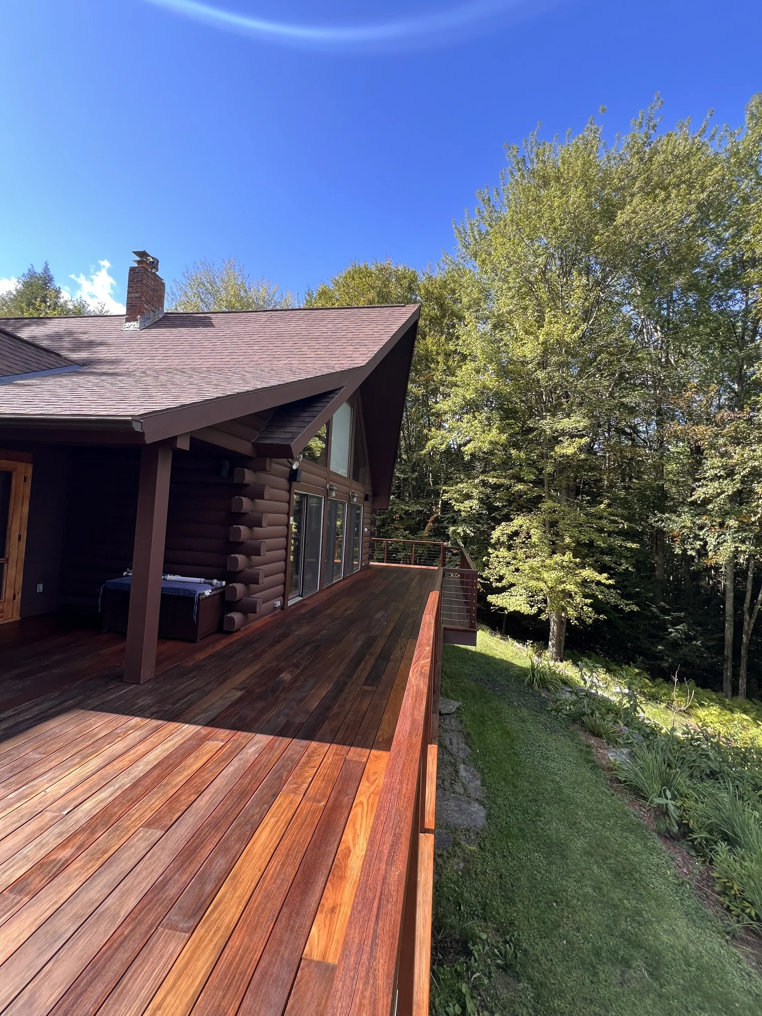 Stained wood deck on Vermont home with rich brown finish and protective exterior seal.