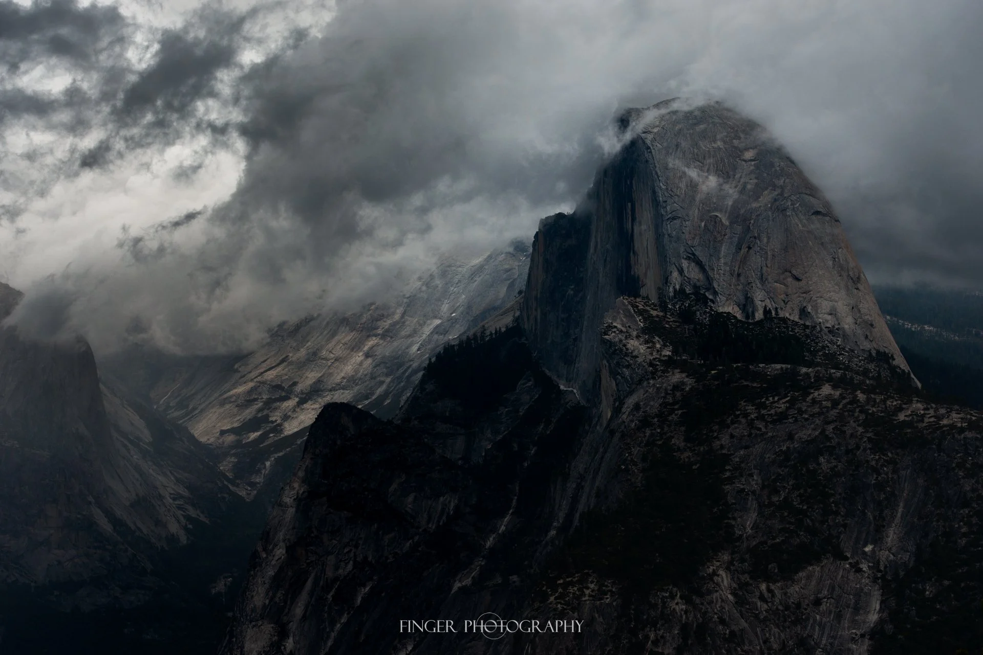 Half Dome starting to poke into the clouds