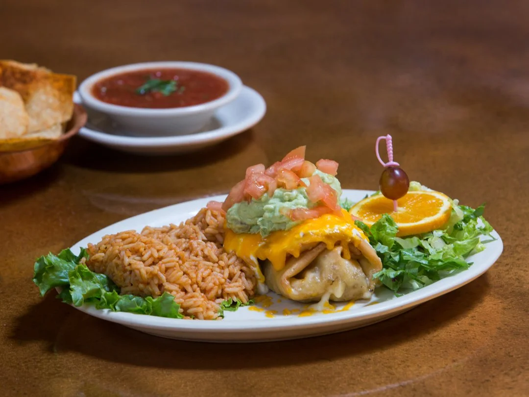 image of loaded burrito with rice and a side of salsa and chips, shot by commercial photographer Corey Rourke

