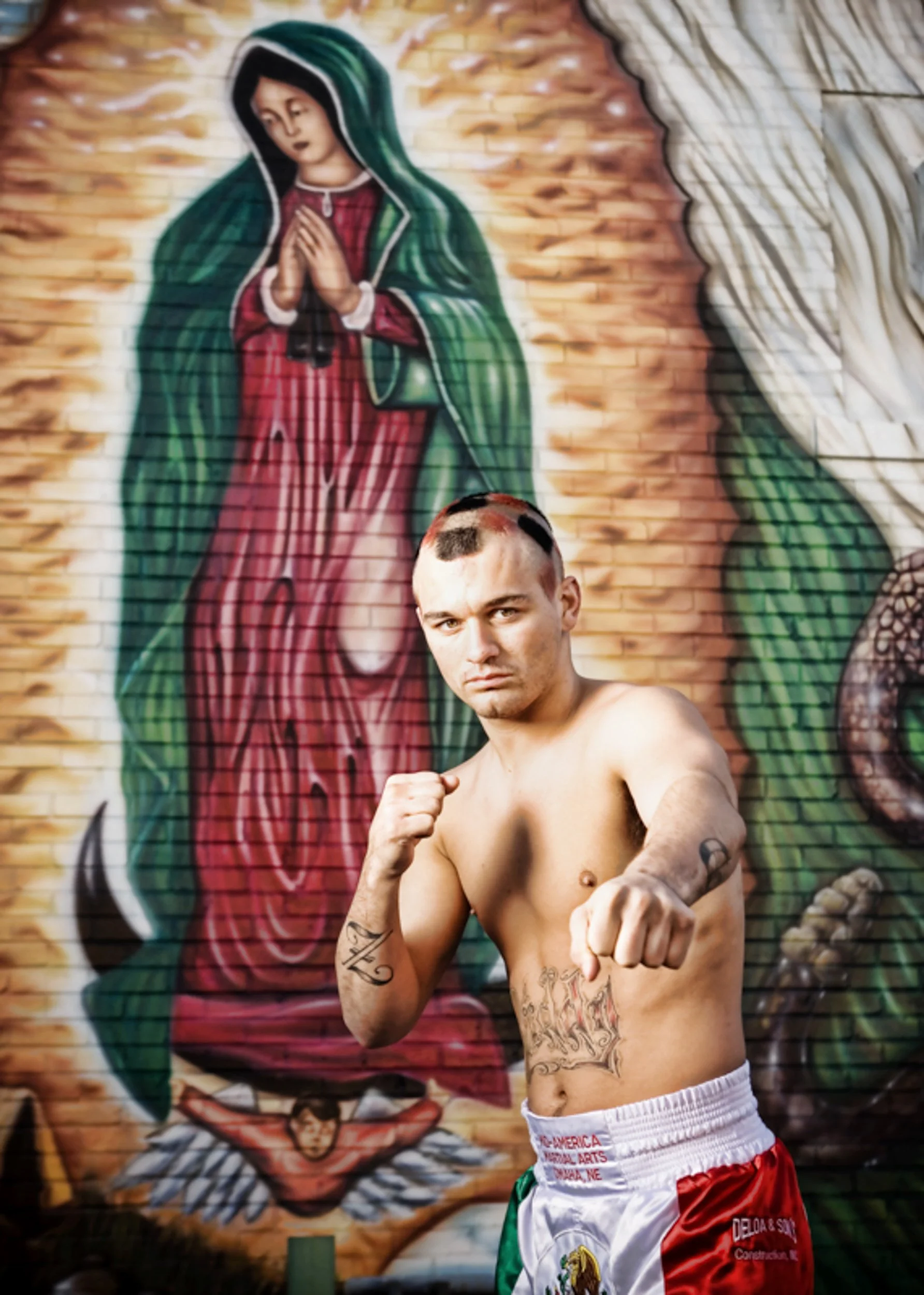 image of boxer throwing a punch with a colorful image of the The Virgin of Guadalupe in background, shot by commercial photographer Corey Rourke


