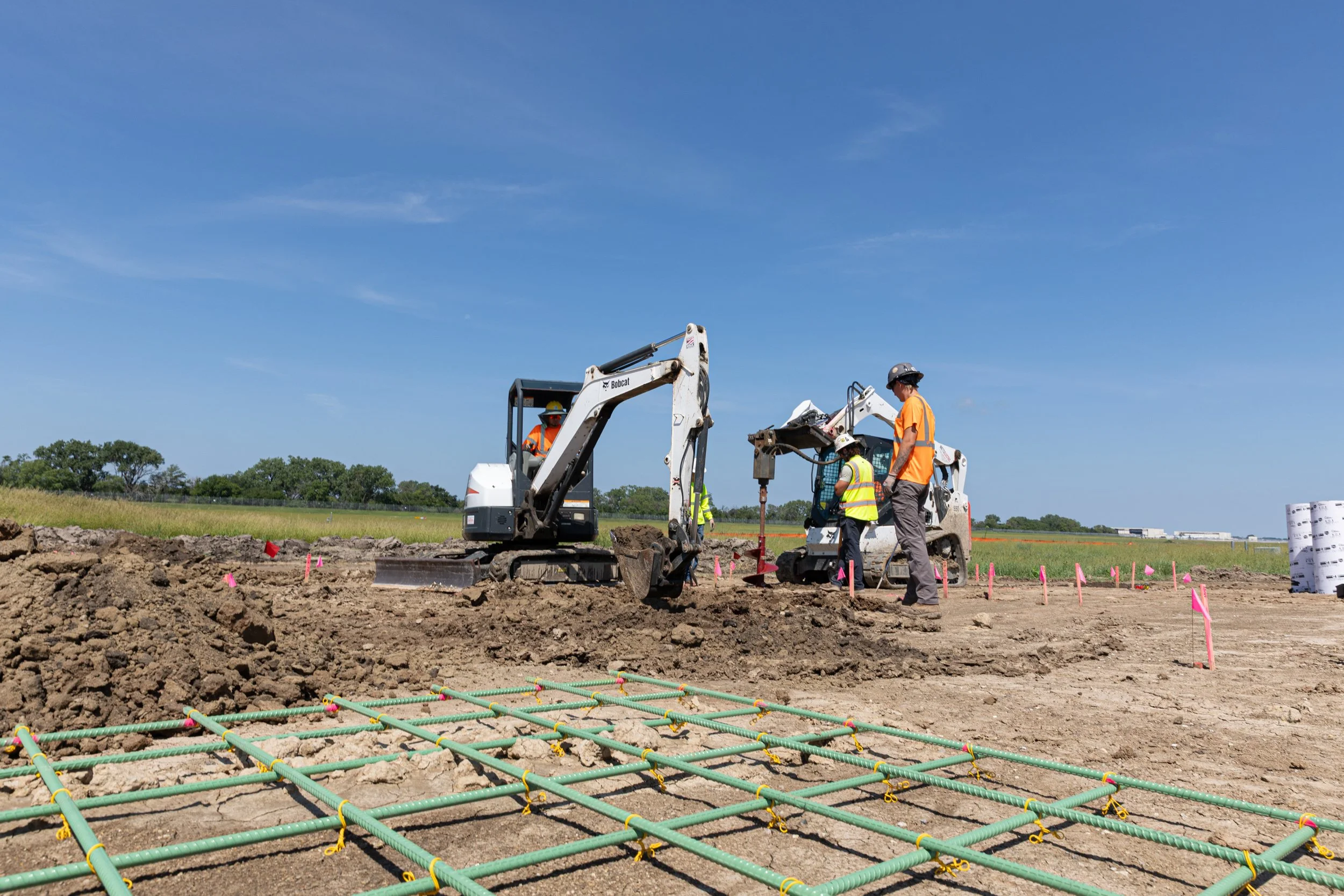 Construction digger at the site making a hole for rebar shot by commercial photographer Corey Rourke