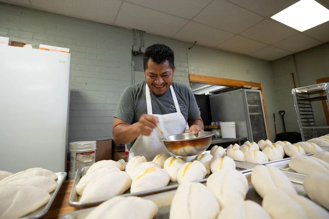 baker buttering mexican pastries, shot by commercial photographer Corey Rourke

