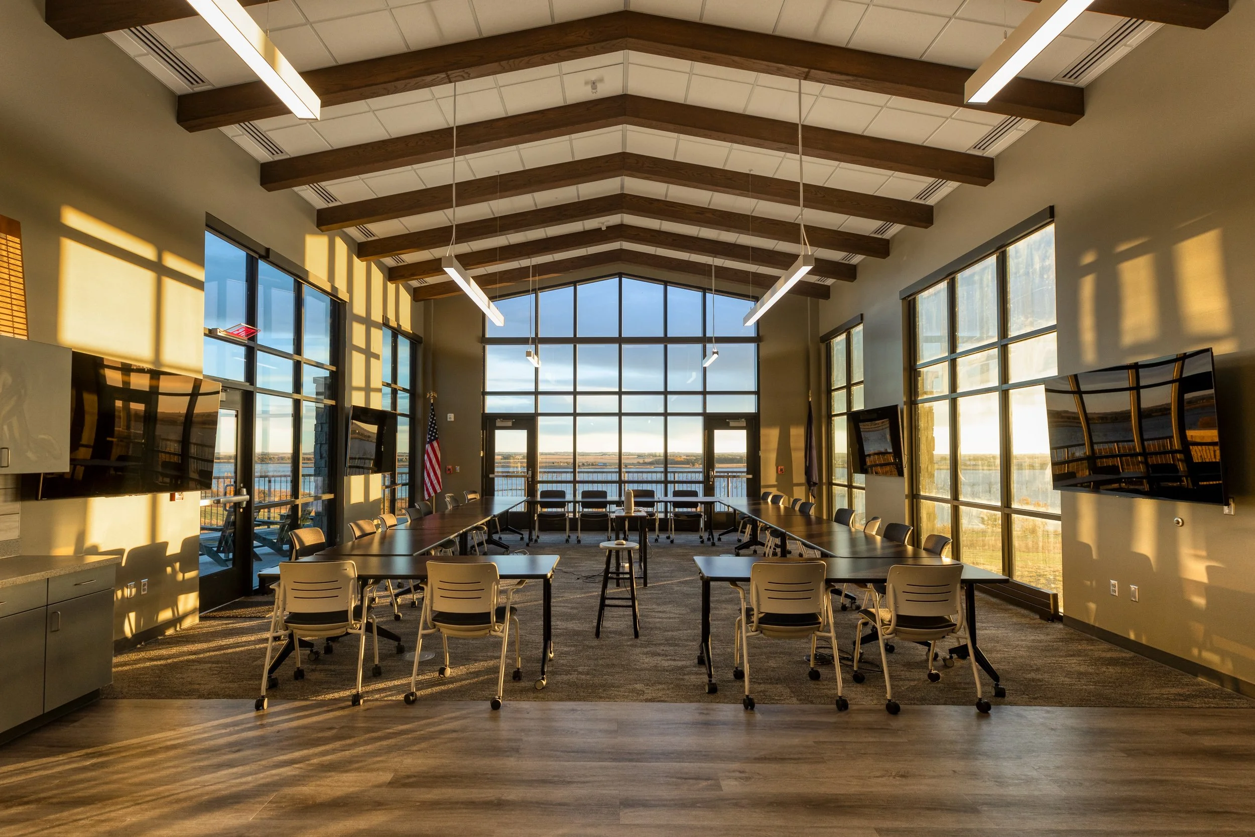 board room at sunrise with large windows.  light coming in make different shadows.
